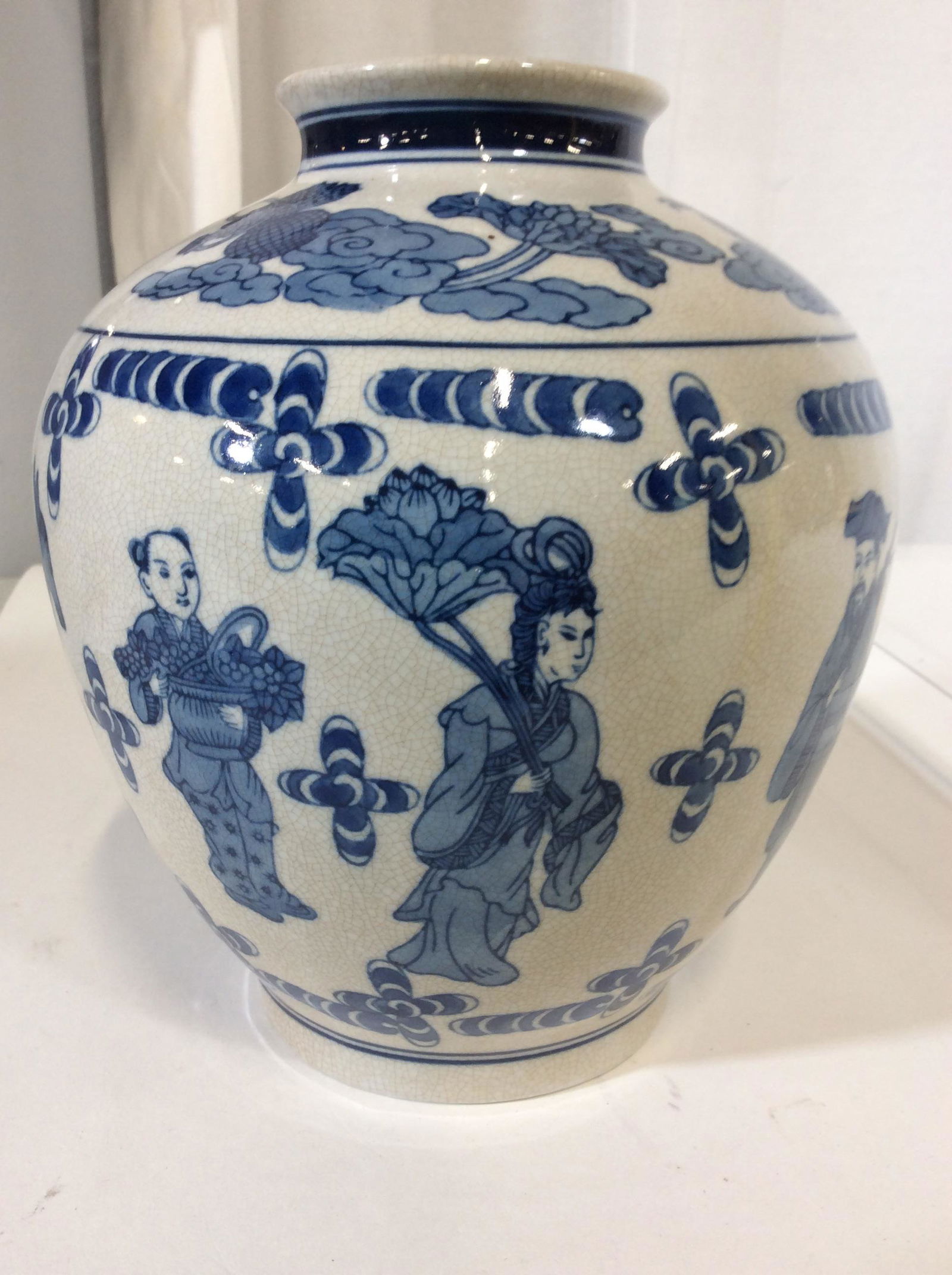 Blue & White Collectible Chinese Ginger Jar: Underside reads Made in China. Depicts men in traditional robes playing musical instruments, on a horse, carrying fruit, or lifting a large leaf or laurel. Matrix of vintage crazing. Thunder cloud bor