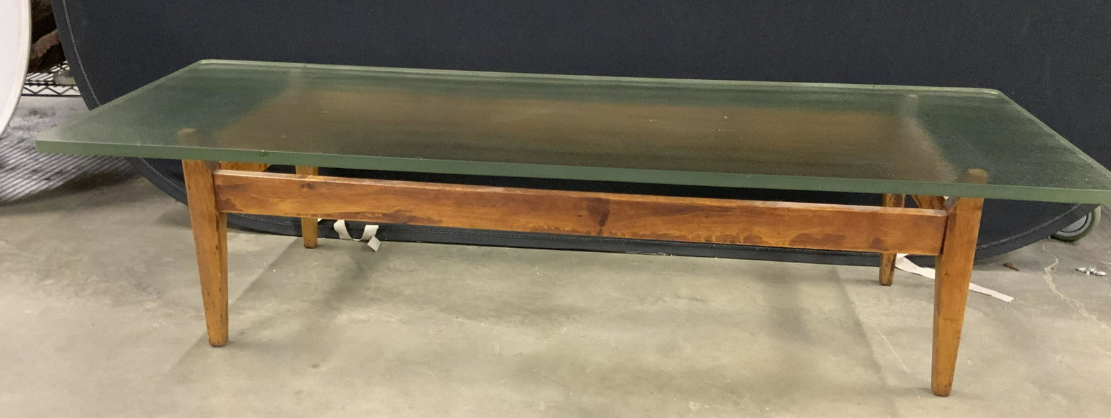Mid Century Modern Wood Glass Coffee Table: Danish mid century modern coffee table, cocktail table, low table, drinks table, wood base, tapered cylindrical legs, shaped sides, hold thick tempered bubble design glass top, property of Manhattan N