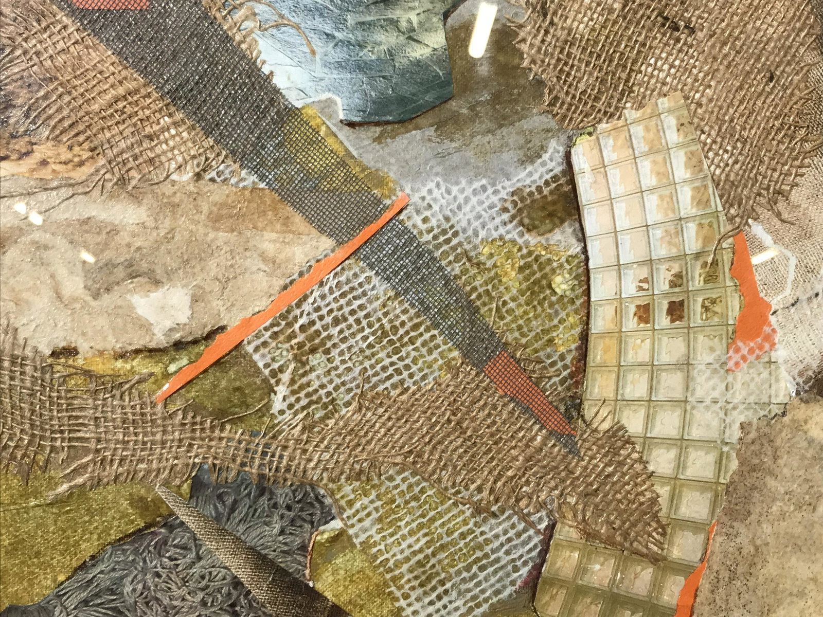 Signed Mixed Collage Helga Brinitzer: Signed mixed media collage on canvas board, signature on reverse reads Helga Brinitzer, subject a collage of burlap various papers among other medias, white matting, gold metal frame, label affixed to