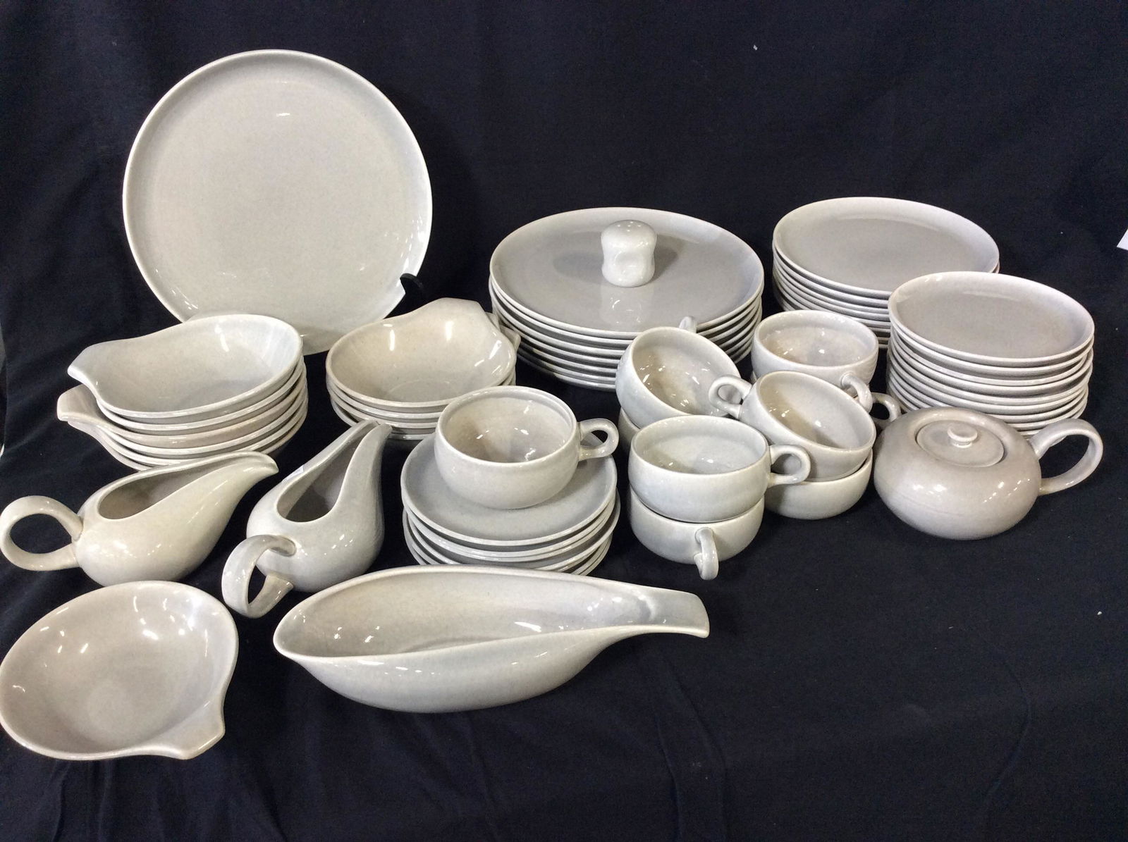 Signed RUSSEL WRIGHT Porcelain Dinnerware, 60 pcs: The Russel Wright American Modern line. Most Dinnerware pieces are labeled with maker’s signature RUSSEL WRIGHT impressed with script writing. Some pieces also marked MFG by STEUBENVILLE. Dove Grey