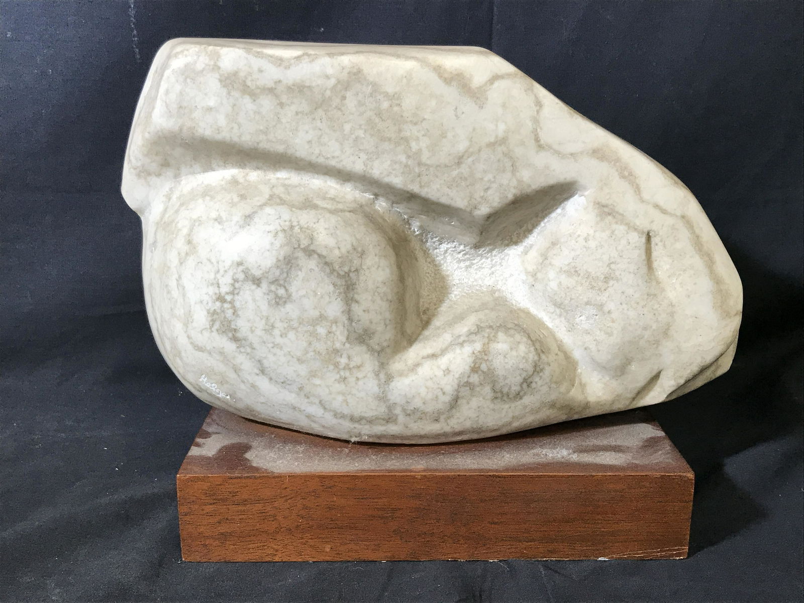 Polished White Variegated Marble Sculpture: Polished White variegated Marble statue with wooden base, signature lower left side reads Helga, subject what appears to be a skull of a creature, white and grey variegated marble, brown wood base, me