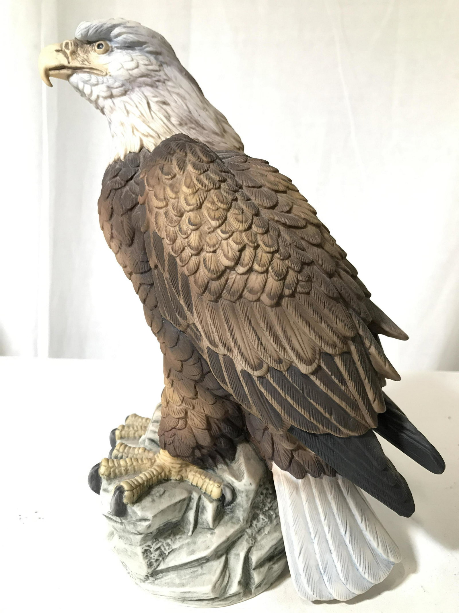 Vintage BALD EAGLE BY ANDREA Figural: Underside of piece is marked BALD EAGLE BY ANDREA. Figural depicts a bald eagle perched on a rock. Piece measures approximately 11 inches tall 5 inches wide 8 inches deep. home decor, animal statuary,