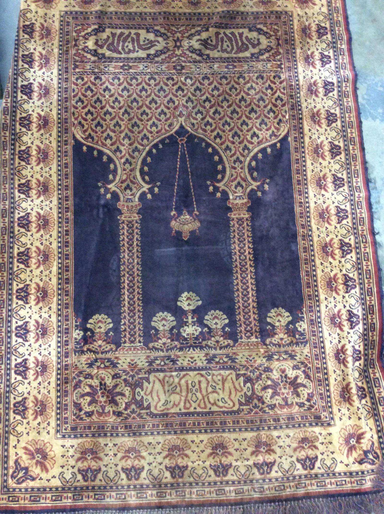 Vintage Middle Eastern Wall Tapestry Textile Rug: Arabic Tapestry, Rug, Textile. Upper & Lower Tassels. Plush fabric, Middle Eastern Design with terrace Architecture, Arabic Writing, floral band border, Browns & rust colors. Sides has some loose stat