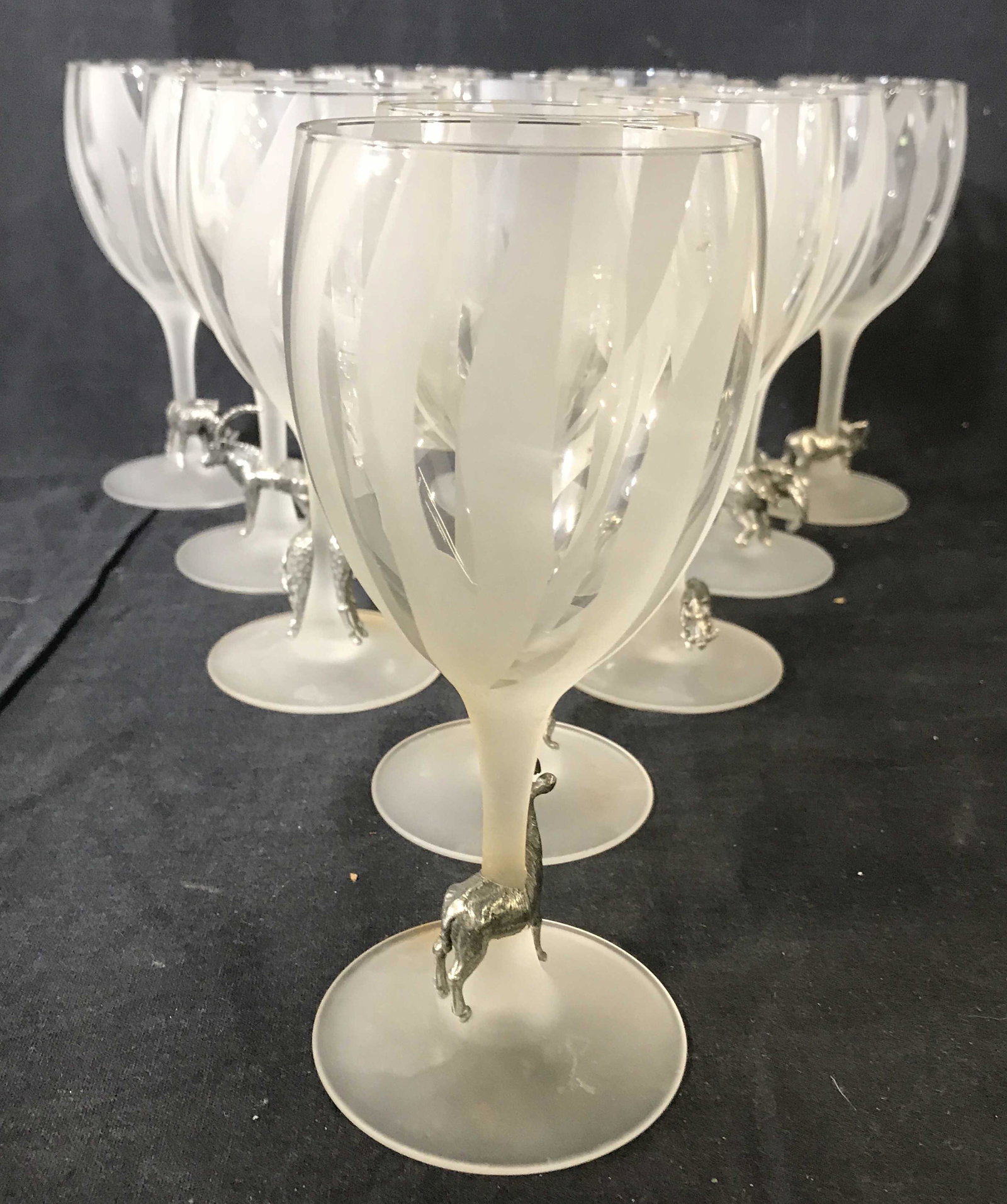 Set 11 ARC FRANCE Frosted Animal Wine Glasses: Lot includes 11 Wine glasses. Undersides are marked ARC FRANCE. Each have pewter animal figure at stem. Each glass has striped frosted detail. Piece measures approximately 7 inches tall 3 inches wide.