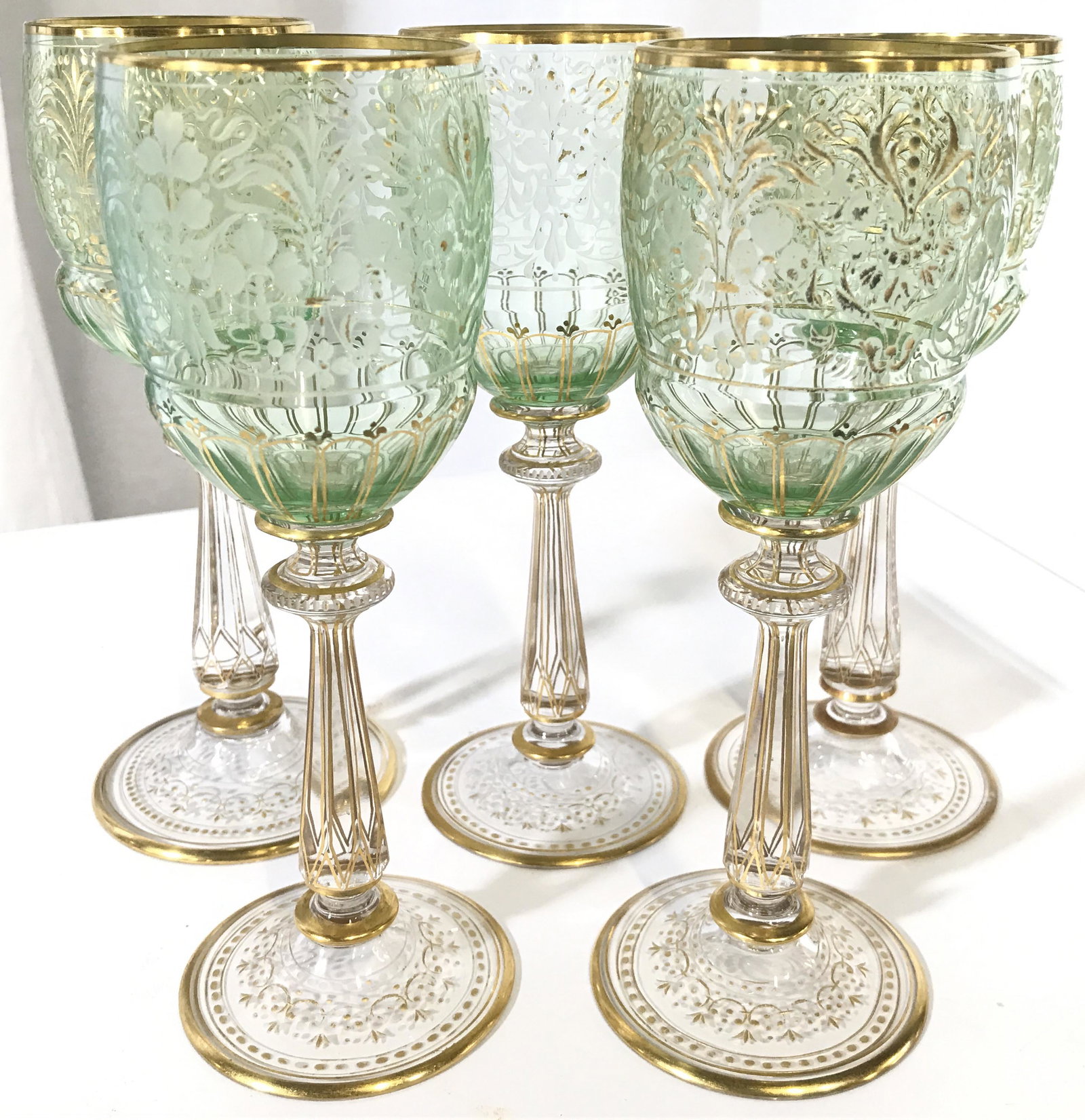 Set 5 Venetian Art Glass Wine Glasses: Lot includes 5 wine glasses. Each have green toned basin with intricate gold toned and frosted detail and clear stems with intricate gold toned detail. Wine glasses, cordial glasses,art glass stemware