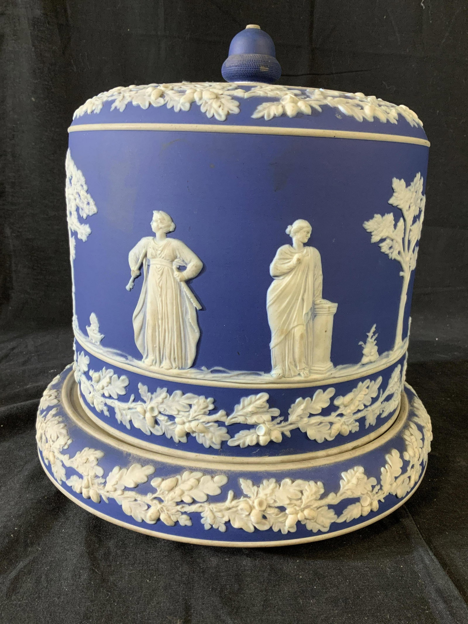 Grand Jasperware Centerpiece Cake Stand: Possibly Wedgwood, English bisque porcelain lidded platter, centerpiece, Roman Grecian Figurals in relief on blue background, measures ht 11.5 inches diameter app 12 inches, vintage possibly antique, 