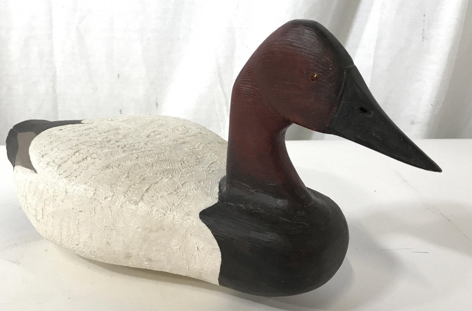 SIGNED CHARLES FISHER Canvasback Duck Decoy: This pieces is a signed, antique, wooden duck decoy. The piece is hand-painted and resembles a Canvasback, a type of diving duck. The piece measures approx 7.5 inches H, and 15.5 inches W. The undersi
