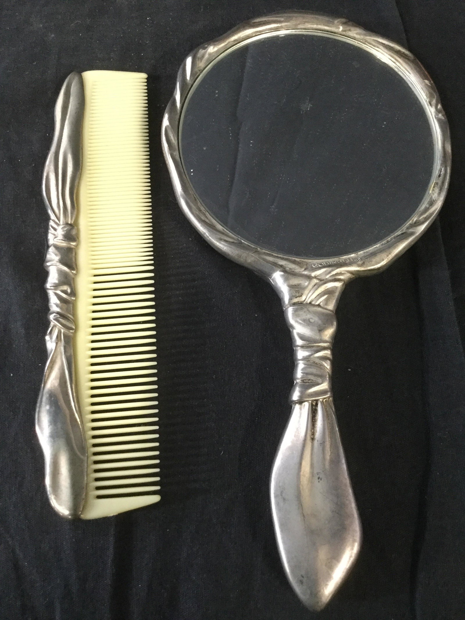 Lot 2 GODINGER Vintage Pewter Comb & Mirror: Lot includes 1 comb & 1 Mirror. Comb teeth appear to possibly be bakelite. Mirror is marked GODINGER. Pieces appear to be pewter. Beauty supplies, beauty accessories, vanity accessories, vintage mirro