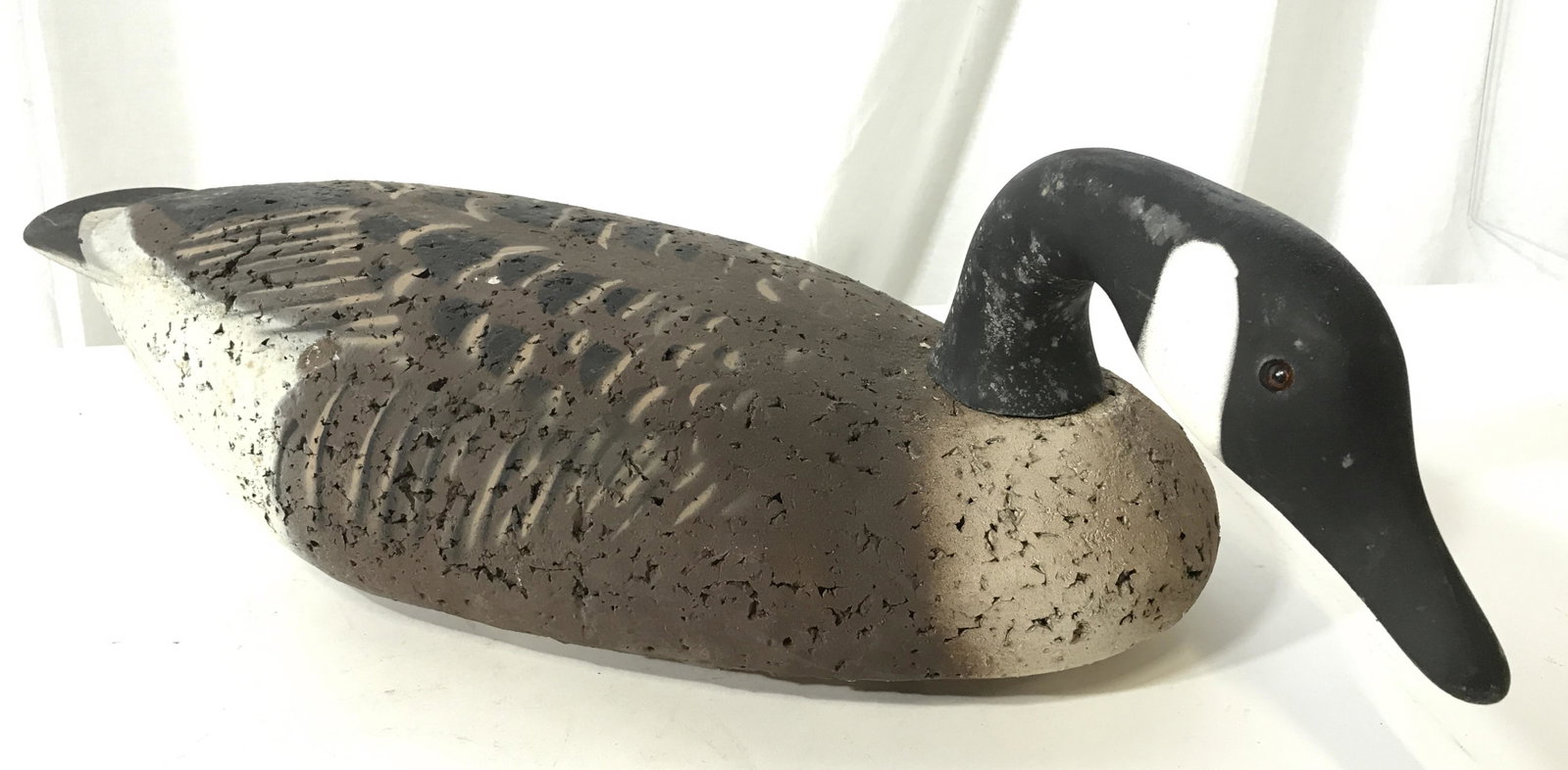 Vintage Canadian Goose Wood & Cork Hunting Decoy: This pieces is a vintage, wooden duck decoy. The piece is hand-painted, the head is wooden and removable, and articulated. The body appears to be crafted from a cork-like material. The decoy resembles