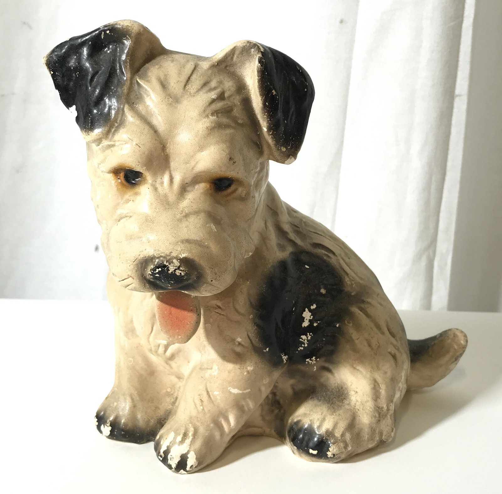 Vintage Plaster Puppy Sculpture: This piece is hand painted and crafted from plaster, resembling a spotted puppy. The statue is vintage, possibly antique. The piece measures approx 7.5 inches H and 7.5 inches W. There is wear present