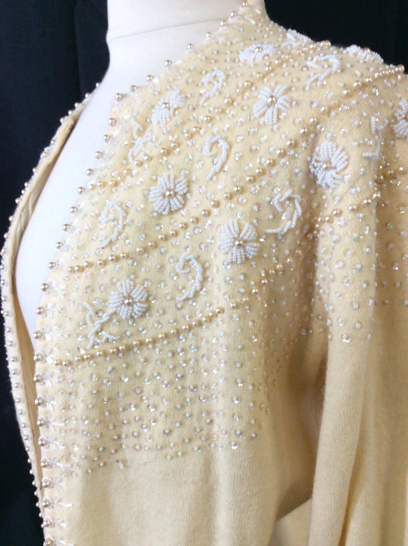Mid Century Beaded Wool Sweater, c. 1950s: Vintage. Size small. Lined sweater, metal hook and latch closure, beaded with costume pearls, sequins, seed beads. Spots of light discoloration in various places. Slight Punctures in sleeve. Discolora