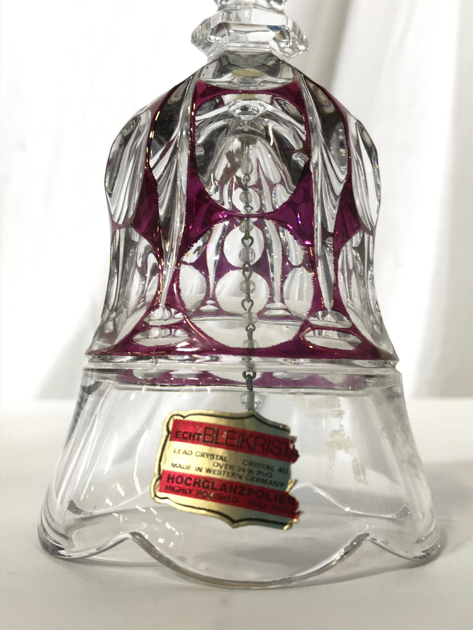 BLEIKRISTALL Cranberry Glass Cut Crystal Bell: Bell has label which reads BLEIKRISTALL. Piece has cranberry tones in certain areas. Bell , crystal bell, cut crystal bell, cranberry glass, tableware, decorative arts and accessories, cranberry glass