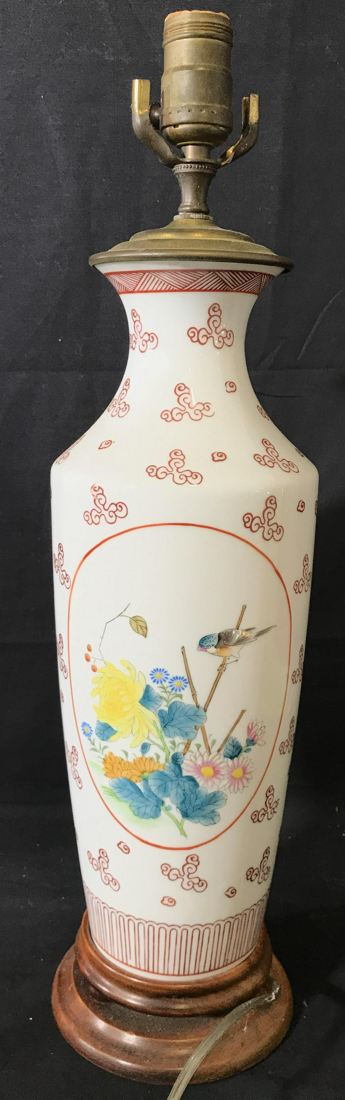 Vintage White Toned Asian Porcelain Lamp: Lamp is porcelain. Piece appears to possibly be hand painted. Base of lamp is wooden. Piece measures approximately 21 inches tall 5.5 inches wide. Lamp, porcelain lamp, table lamp, painted lamp, Asian