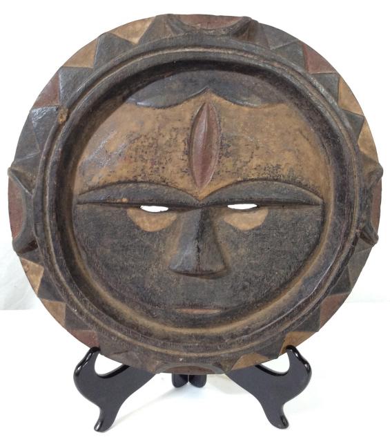 EKET Wooden Tribal Sun Mask, Nigeria: This is a Wooden Tribal Sun mask, the piece is crafted by the EKET people of NIGERIA. The piece is possibly antique. The piece is colored in earthy tones, and measures approx 11.5 inches in diameter. 