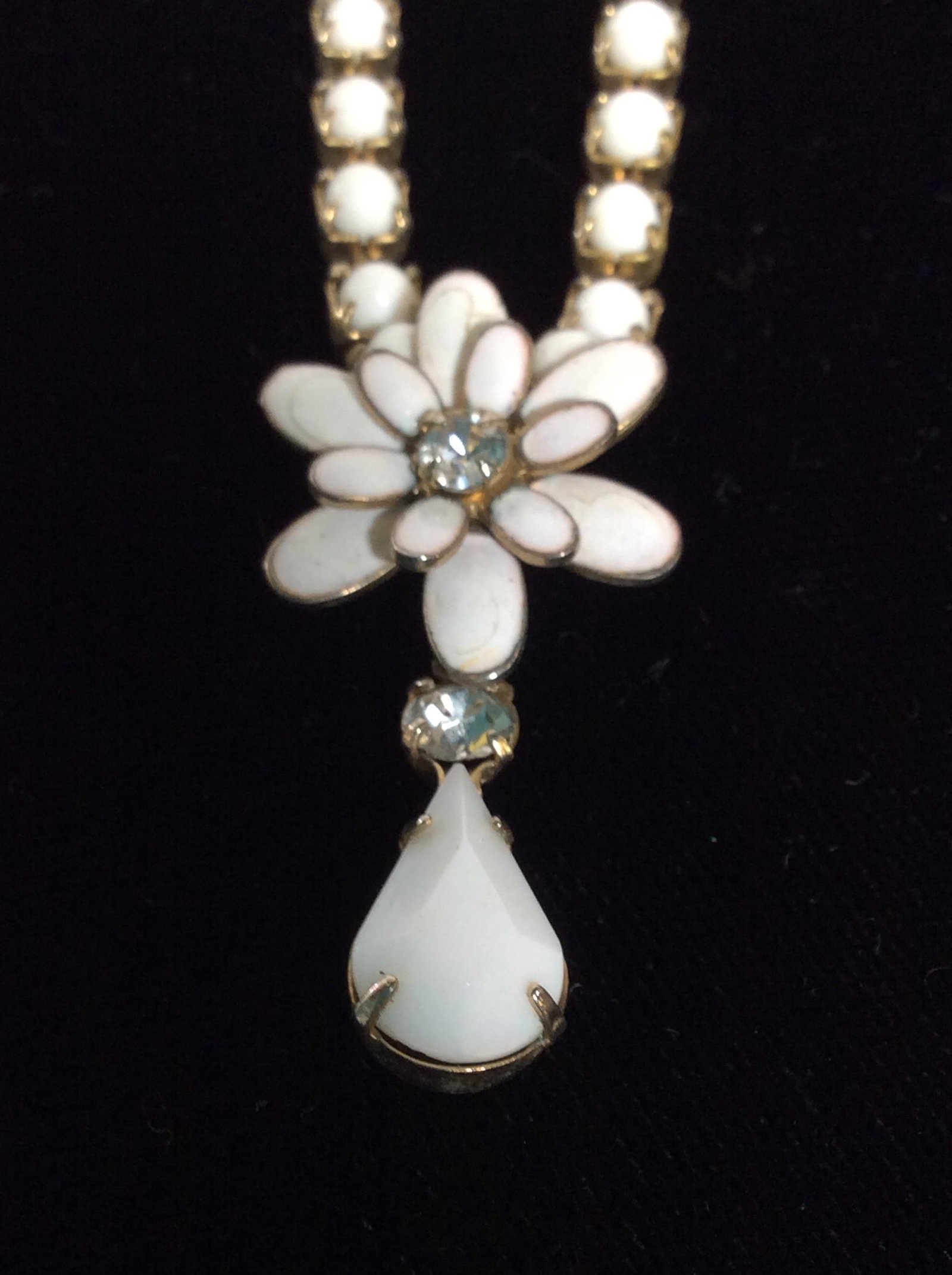 Mid Century Enamel Flower Pendant Necklace: Teardrop and rhinestone bead dangle under a white enamel flower. Chain with individual white round beads in prong Setting. Hook clasp. Chain 14 in. Costume Jewelry, Mid Century Jewelry, White Enamel F