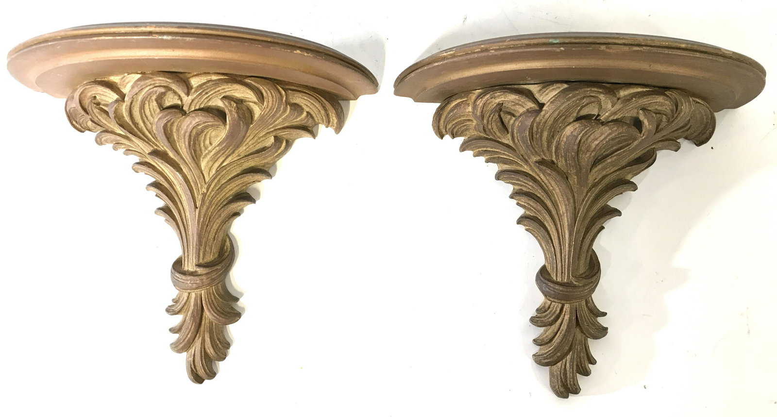SYROCO WOOD Gold Leaf Wooden Wall Shelves: Backside of piece has tag which reads SYROCO WOOD SYRACUSE NY. EACH wall shelf has bunched leaf detail. Tops of each have half circle shape. Shelves, wall shelves, gold leafed wall shelves, pair wall 