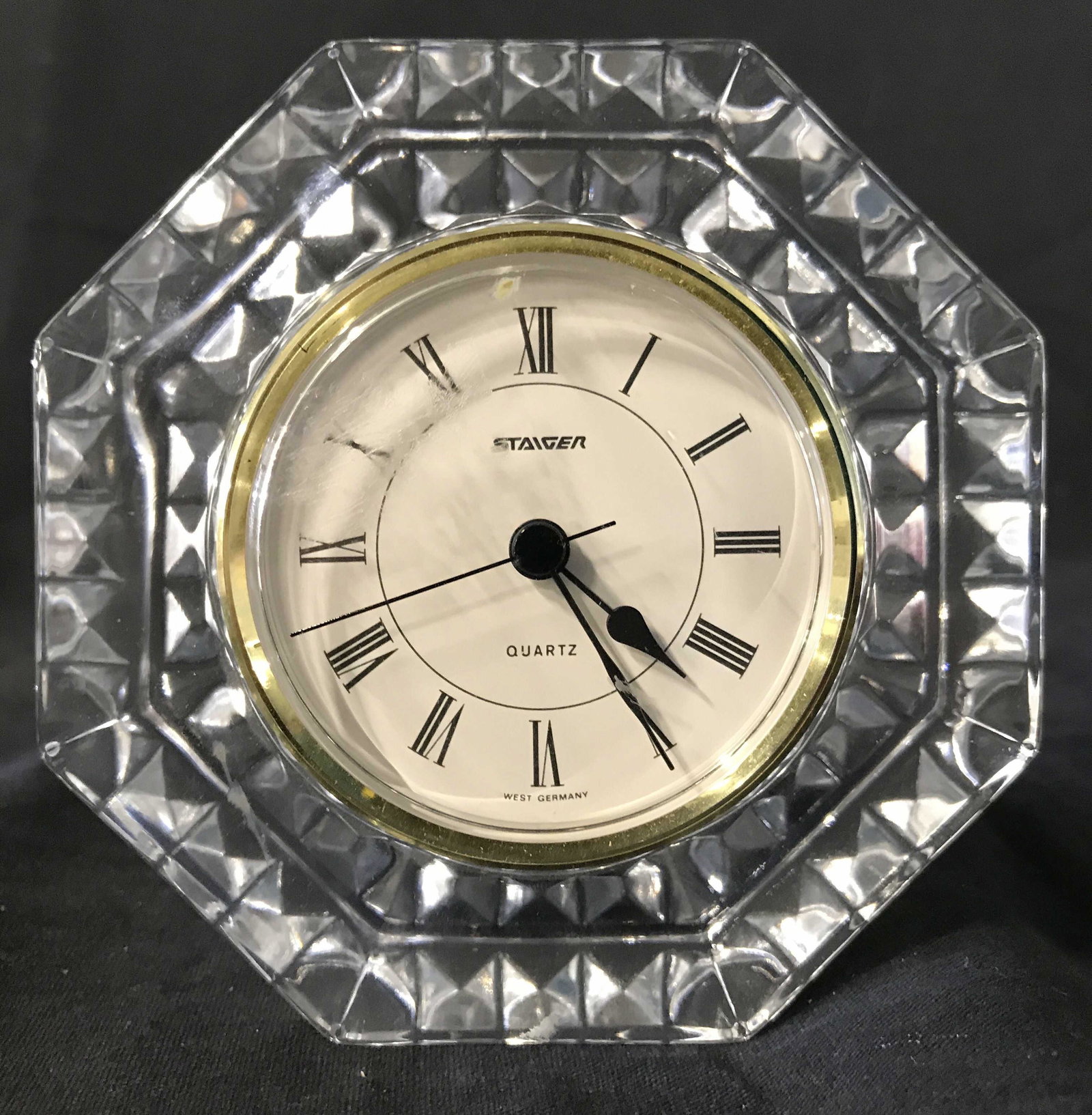 Vintage STAIGER Desk Clock: Clock face reads STAIGER WEST GERMANY Backside of piece reads FRANCE. Desk clock is octagonal shaped. Clock is vintage. Clock has black toned Roman numerals. Piece measures approximately 4.75 inches t