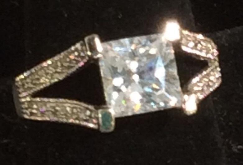 EDCO Clear Crystal Cocktail Ring: Princess cut solitaire with ‘V’ shape shanks, channel set with diamanté stimulant. Center stone 8x 8 mm. Size 10-11. Costume Jewelry, Cocktail Ring, Costume Wedding Engagement Ring, Ladies Fashio