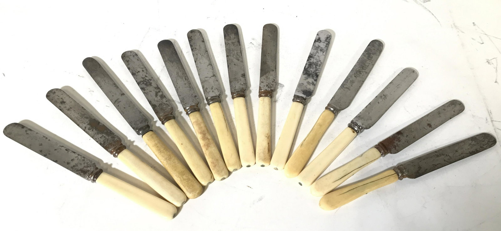 13 Carved Bone & Bakelite Handle Spreading Knives: Lot includes 13 spreading knives each appear to have carved bone or Bakelite handles. Spreading knives are vintage. Some are marked HARRISON BROS & HOWSON while others are marked JOSEPH RODGERS & SONS