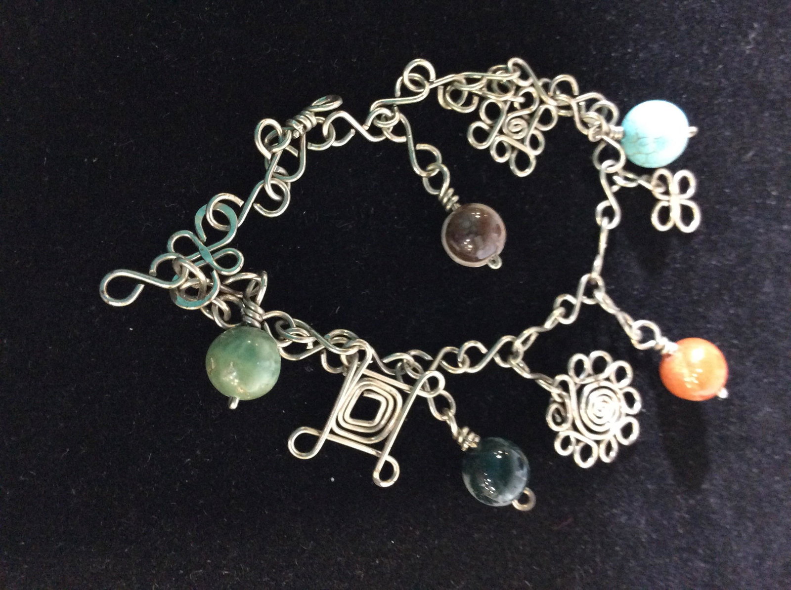 Lot 3 Artisanal Mexican Charm Bracelets: Modern bracelet, all silver tone, charms are Itza Pyramid, Turtle, Dolphin, & Mayan Medallion. 7.5 in. Vintage Bracelet, charm beads, crafted metal designs. Pull through clasp similar to a toggle. app