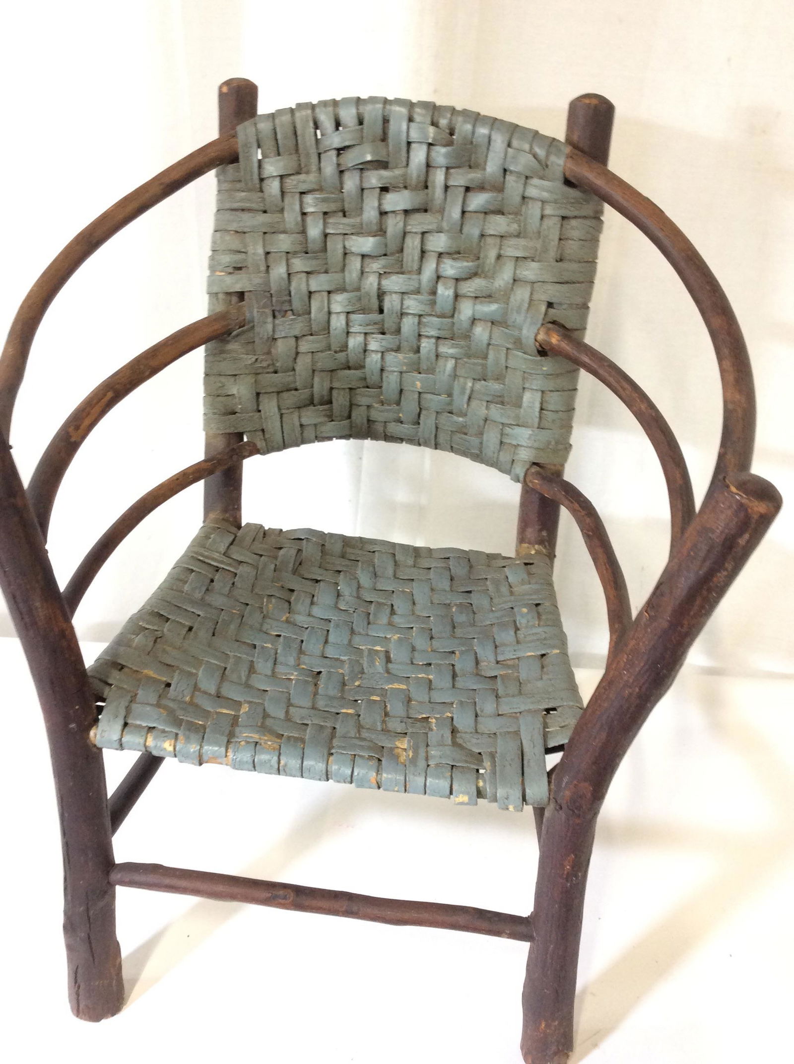 Vintage Child’s Basket Weave Wood Chair: Handmade vintage chair ( possibly antique) for a child. Painted woven back and seat. Hand nailed and creatively crafted with app 2 in wide tree branches, dark wood stain. Seat measures 11 in. long by