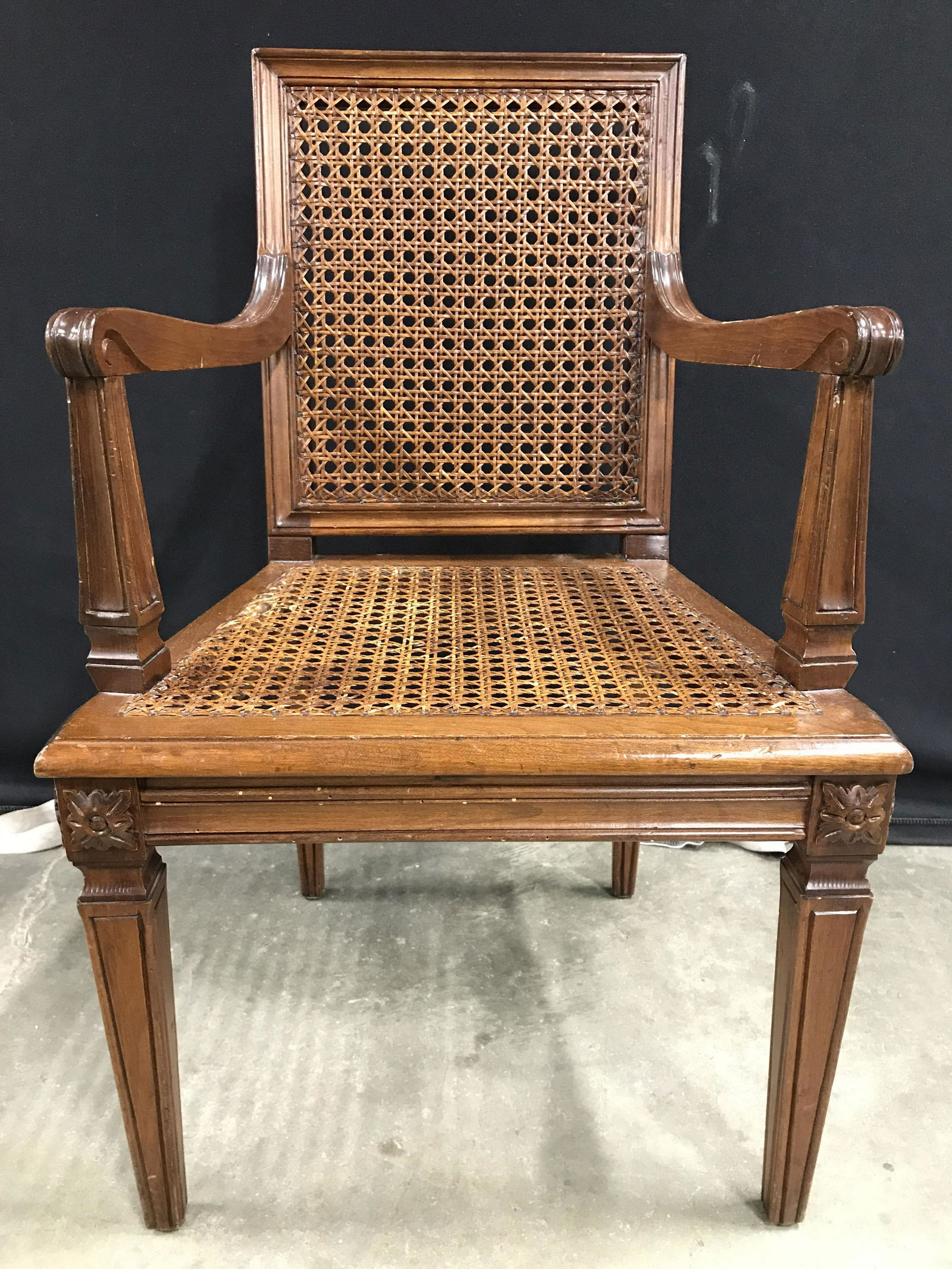Vintage Caned Carved Wooden Child's Chair: Chair is vintage possibly antique. Piece has carved wooden detail, possibly hand carved. Backrest and seat of chair is caned. Chair is brown toned. Piece measures approximately 28 inches tall 17 inche