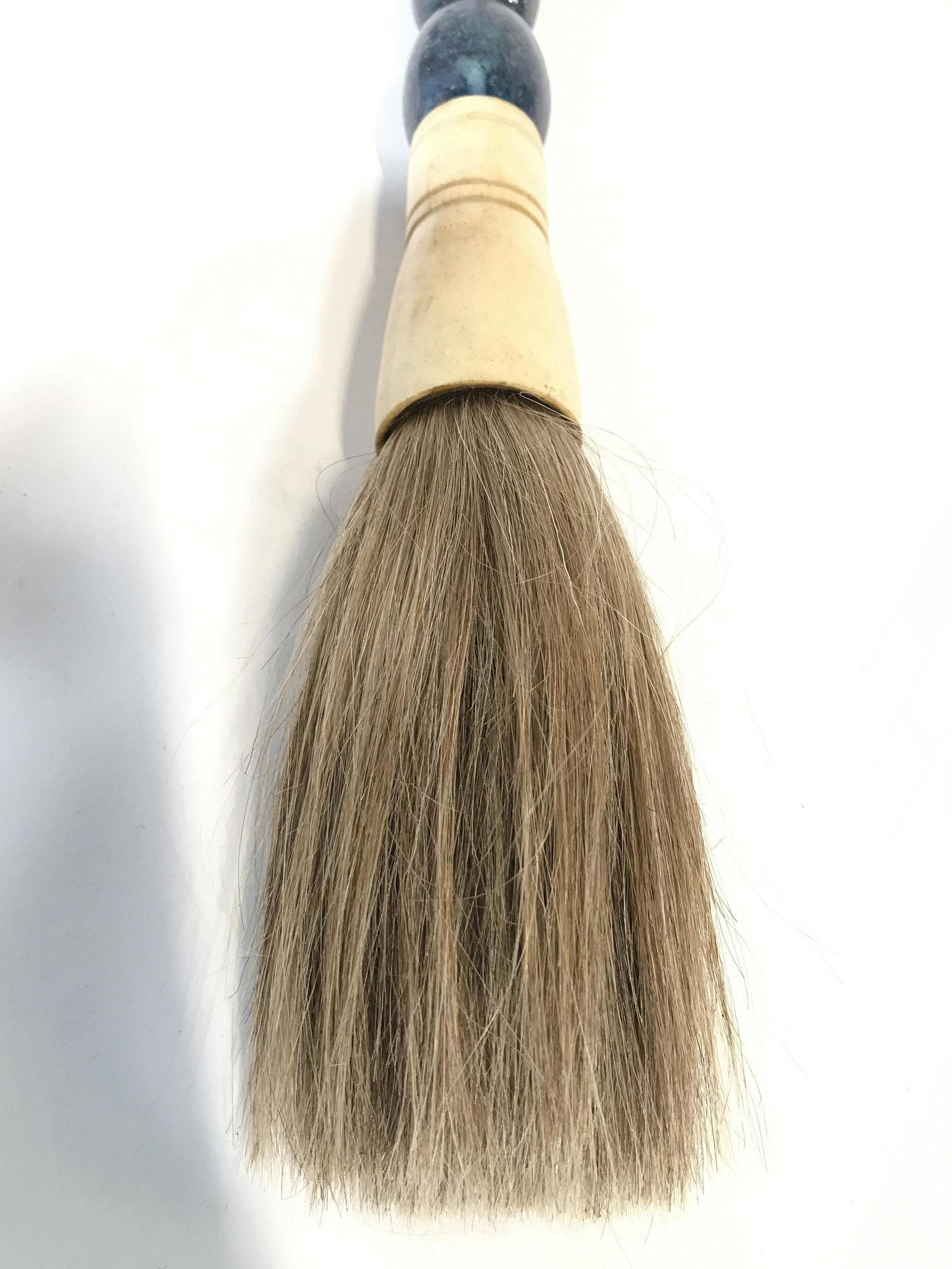 Carved Bone Stone Handle Calligraphy Brush: Calligraphy brush has blue toned stone handle with carved bone structures at ends. Piece measures approximately 16 inches long 1.5 inches wide. Brush, calligraphy brush, stone handle calligraphy brush