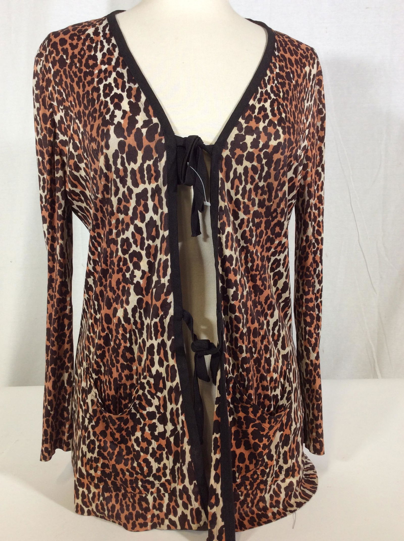 Animal Print Slinky Fabric Cardigan: Front pockets, fabric tie closures, app 27 in. long. Puncture to left backside shoulder. Size Small. Wearables, Ladies fashion clothing, cardigan blouse, animal print, Casual wear, 3