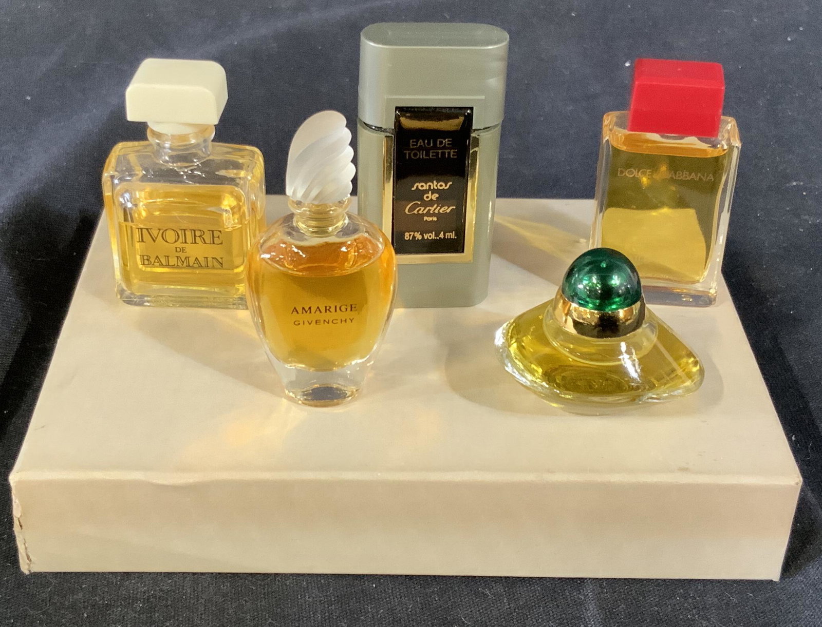 Assortment of Luxe Perfumes: Assortment of five Luxe perfumes, each on its own designer bottle, brands include, Oscar de la Renta, Cartier, Balmain, Givenchy, and Docle and Gabbana, all bottles have their signature scent inside, 