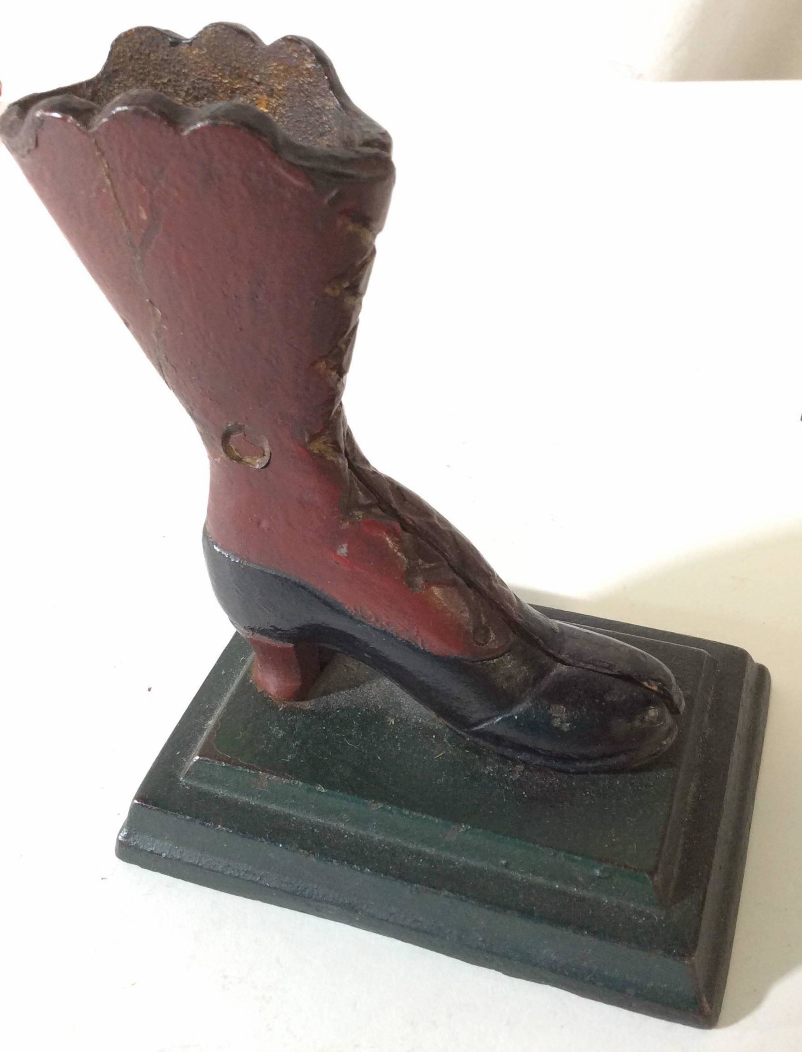 Antique Cast Iron Mechanical Saloon Boot: Painted iron female boot, possibly antique. Previous use as a match holder. Appears to have had mechanical movement from lever on underside that would lift the boot up from the toe. Circa early 1900��
