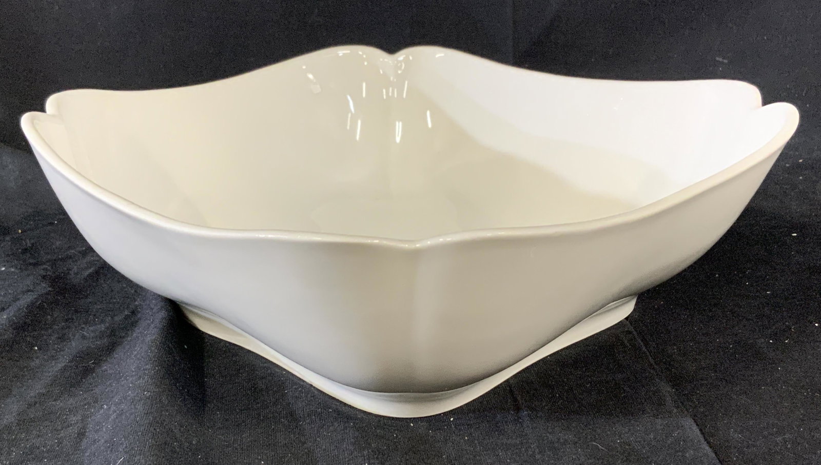 Scalloped Edged Centerpiece Bowl: White ceramic serving dish with gently scalloped edges, water safe, floral markings on the reverse, classic minimalist style, bowl measures 9 inches across both ways, measures 3 inches deep, Serving d