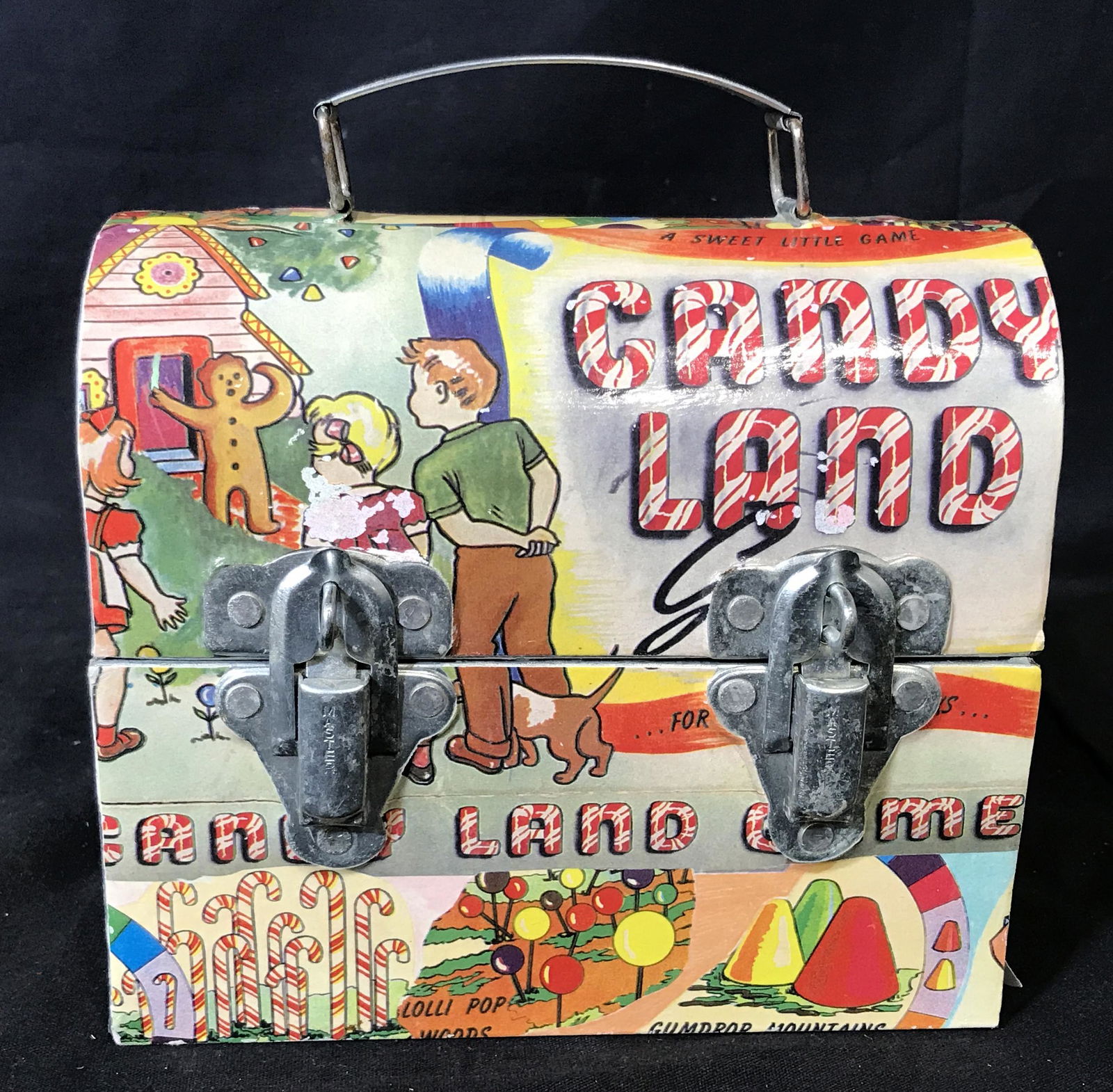 Vintage Candy Land Lunch Box: Vintage candy land lunch box, Metal with paper detailing, label to bottom reads ‘The Macbeth Collection West New York NJ’, some wear to paper designs, some edges coming up on paper, measures 6.25