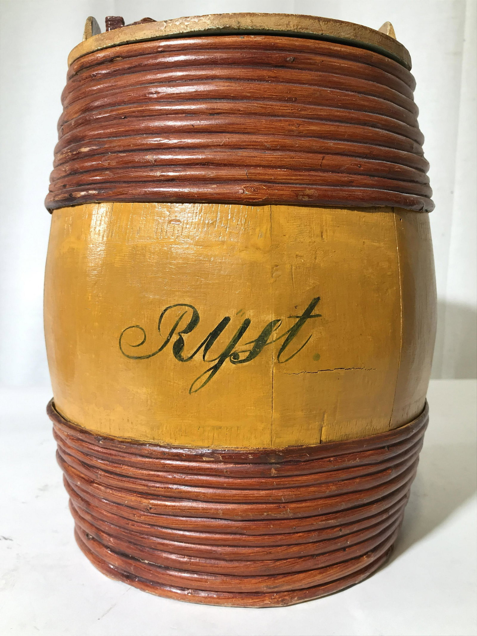 RYST Vintage Wooden Decorative Aging Barrel: Piece appears to be hand painted. “RYST” Is painted on front. Piece is yellow and light brown toned. Crafted from wood. Piece includes lid, Interior is light green toned. Piece measures approximat