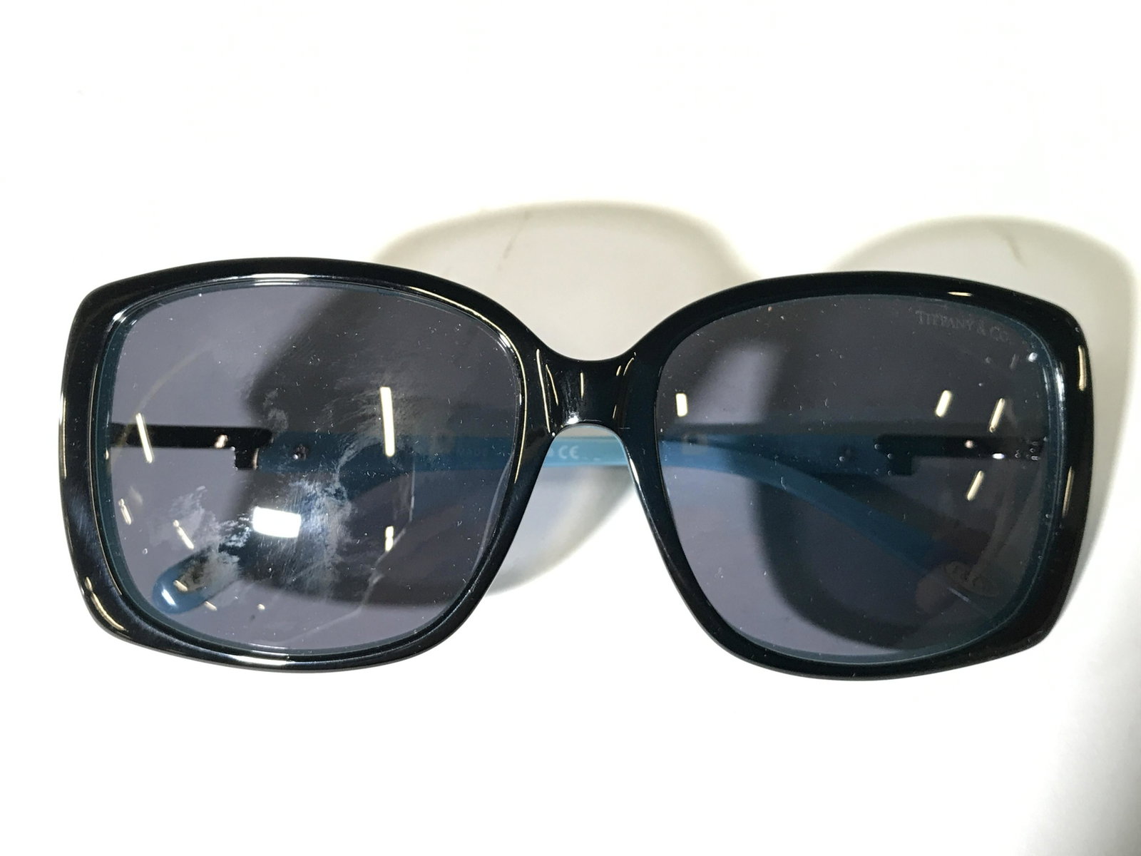 TIFFANY & CO Sunglasses W Case: Glasses case, glasses, & 2 cleaning cloths are marked TIFFANY & CO. Sides of glasses, decorated with rhinestones, Each piece has light teal tone. Glasses measure approximately 5.25 inches wide 5.5 inc