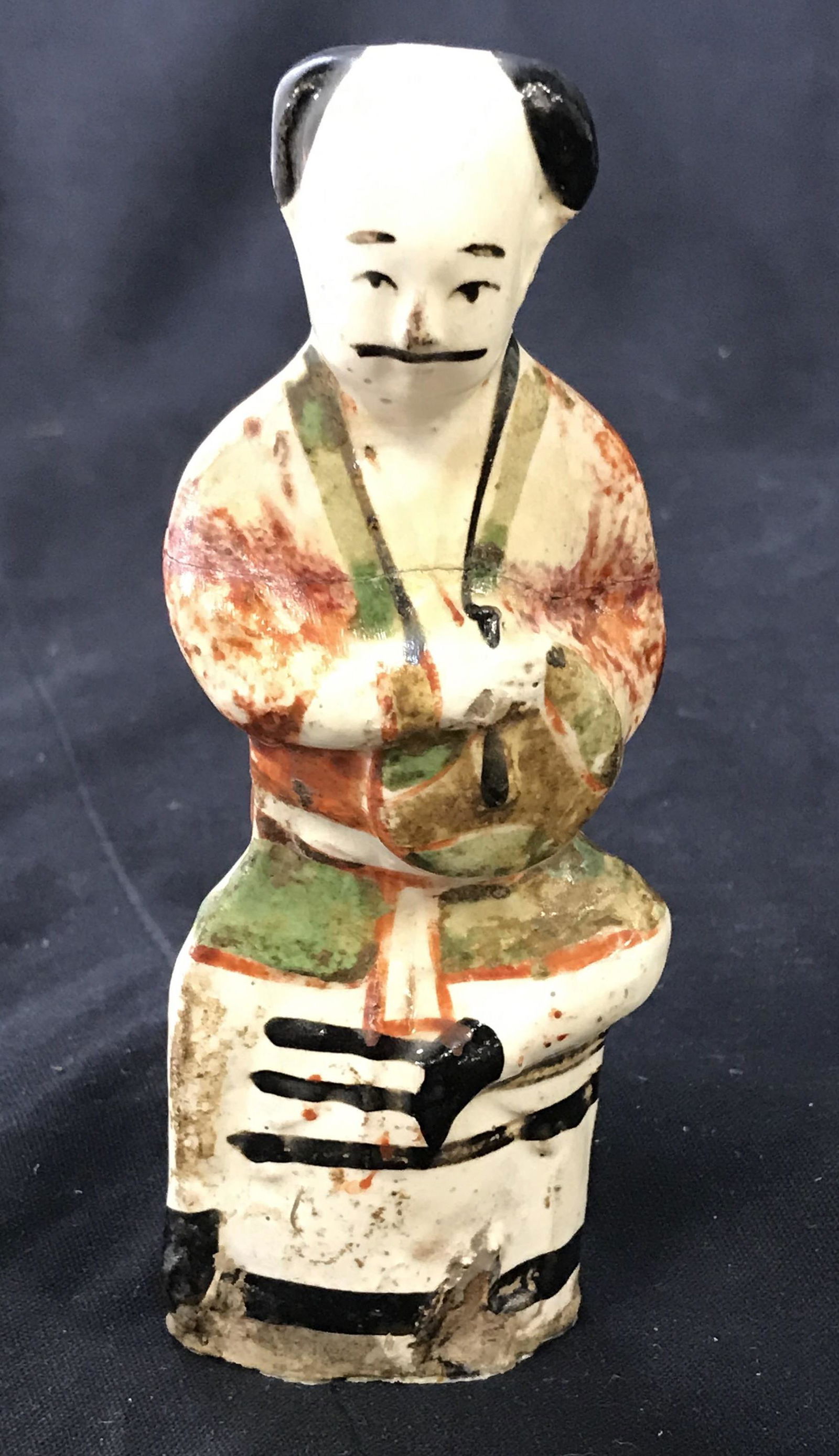 Vintage East Asian Style Ceramic Figure: Vintage, possibly antique ceramic figure. Depicts a mustached man sitting down. Piece measures approx 5.5 inches H, and 2.25 inches W. Wear is consistent with age, repairs have been made to piece, chi