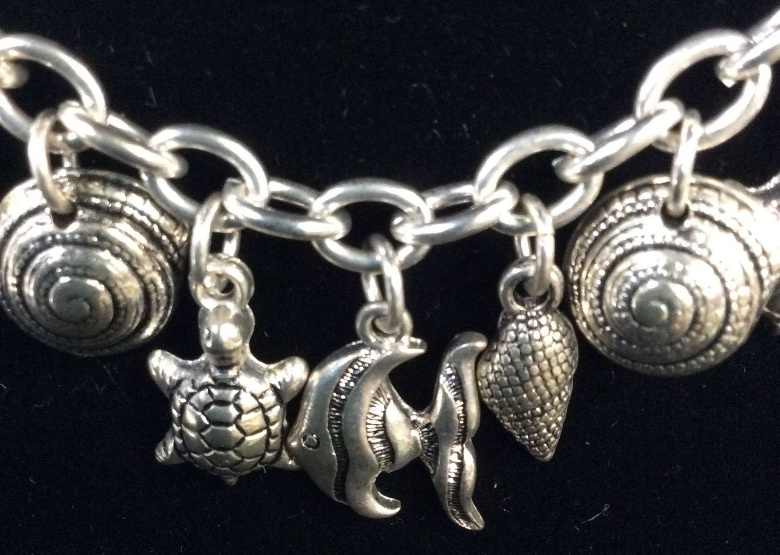 Nautical Silver Toned Shell Charm Necklace: Adjustable necklace, 18 in. longest length, various sea shells, turtles, starfish, goldfish charms lined across center. Charms dangle app .5 in. Beach Wear Jewelry, Nautical Fashion Necklace, Ladies S