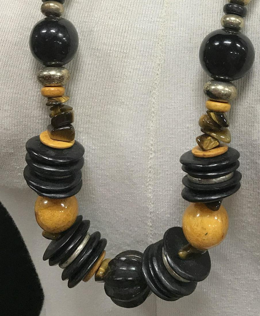 Statement Tribal Bead Necklace, Multi Material: Tiger Eye, Silver Tone Metal, Flat Wood Discs, Oversize beads make up this opulent Artisan Necklace, 30 in, hand strung, large c spring clasp. Statement Tribal Style Necklace, Tigers Eye, Round Disc P