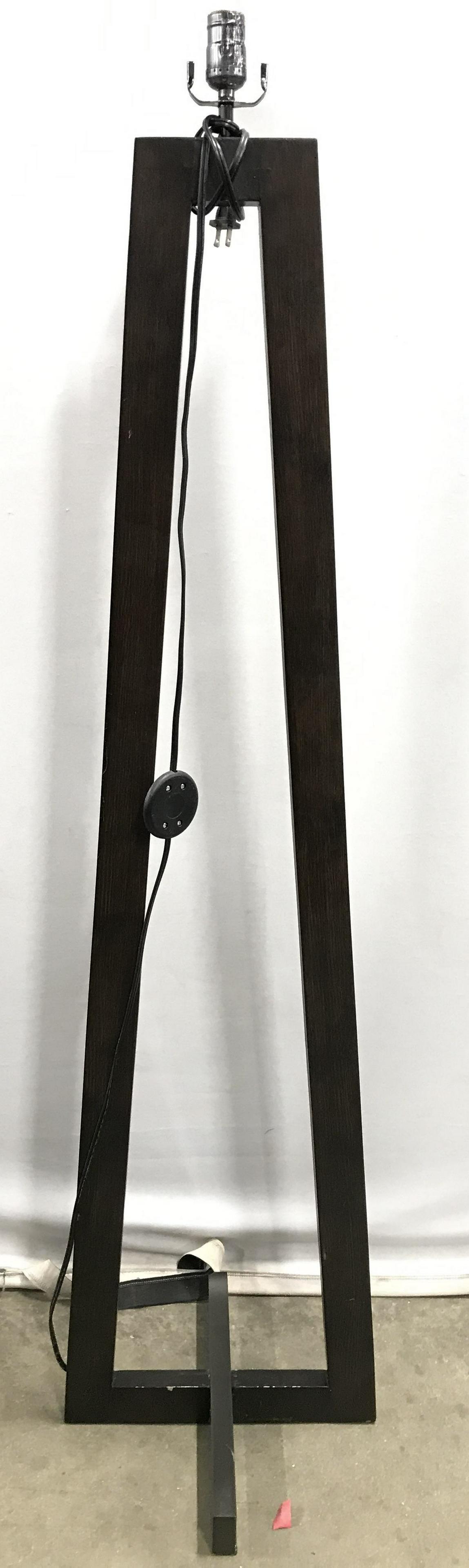 Mid Century Modern Floor Lamp: Floor Lamp is mid century modern. Piece is brown toned appears to be wooden. Piece has slim pyramid style structure. Lamp, floor lamp, mid century modern floor lamp, wooden lamp, floor lighting. home 