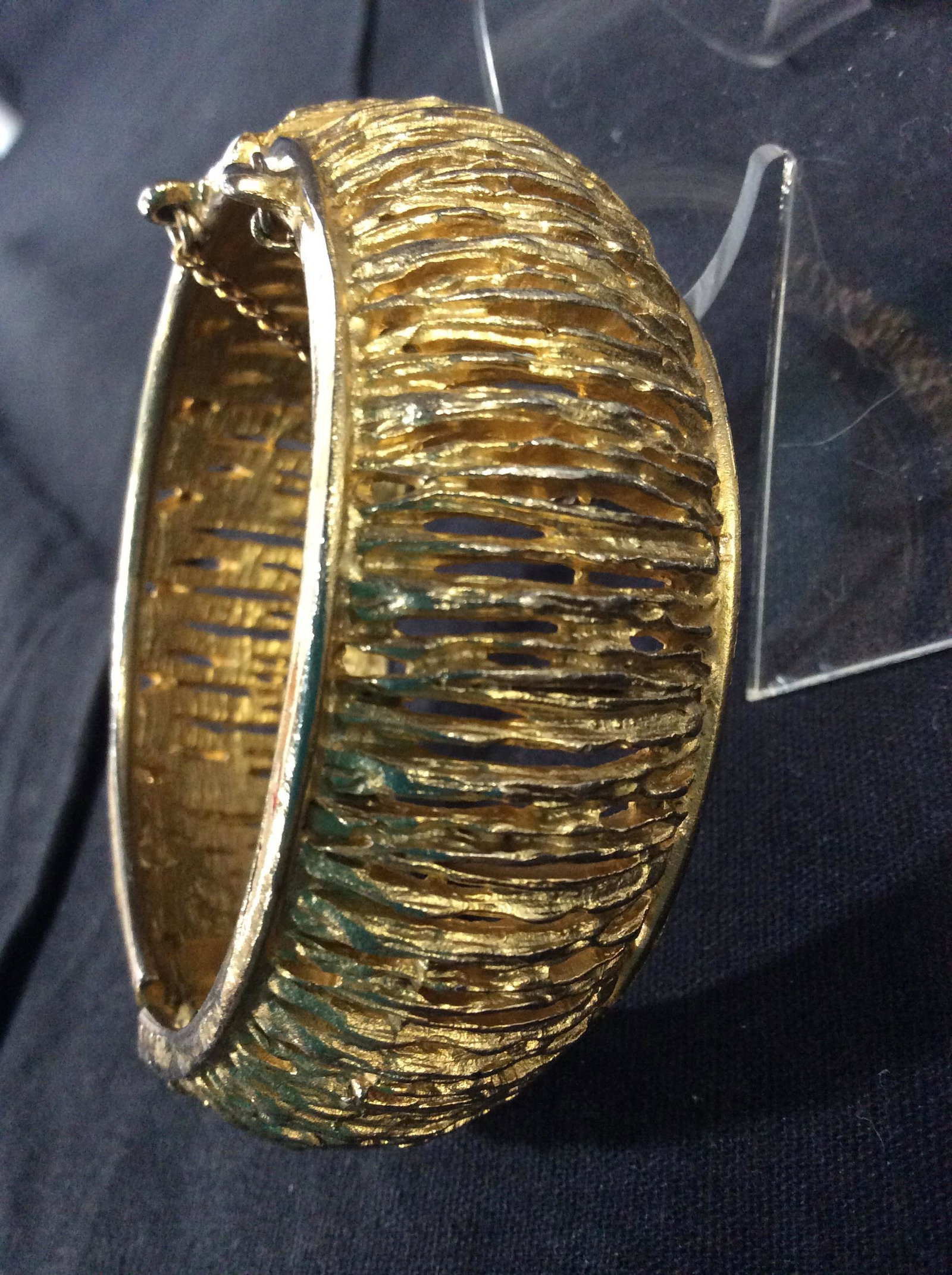 Gold Tone Pierced Metal Fashion Bangle: Bangle design width 1 in, 2 1/4 in wrist width, hinge mechanism, safety chain attached. Pierced line design. Cocktail Cuff Bangle Bracelet, Fashion Jewelry, Gold Tone Fancy Pierced Metal Bangle, Ladie