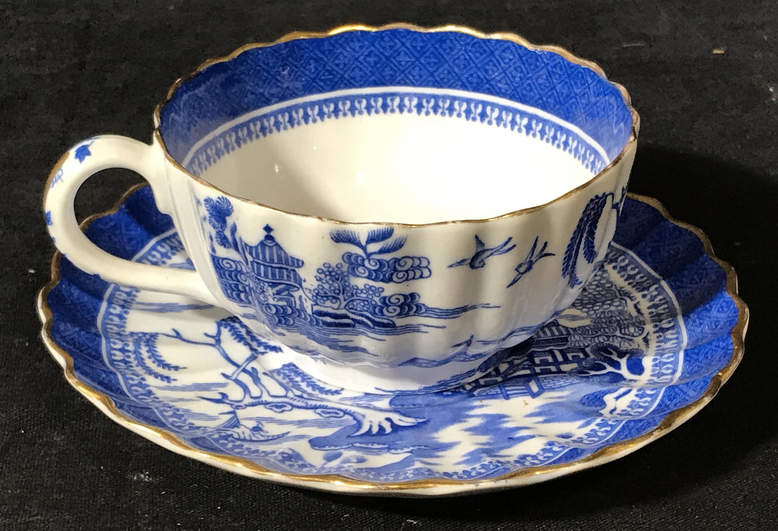 Spode Copeland Porcelain Teacup & Dish: Spode Copeland porcelain teacup, Asian style design to cup and dish in blue and white, design depicts a palace scene, bottom of cup and dish read ‘Spode Copeland 23’, both have gold detailing to t