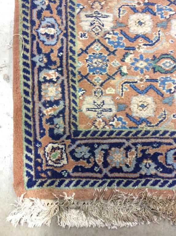 Vintage Handmade Oriental Wool Rug: Rug is wool & handmade. Rug contains fringes. Contains multi toned floral leaf & vine detail. Contains tones of coral, grey, brown, tan,cream, light green. Rug, carpet, area rug, area carpet, handmade