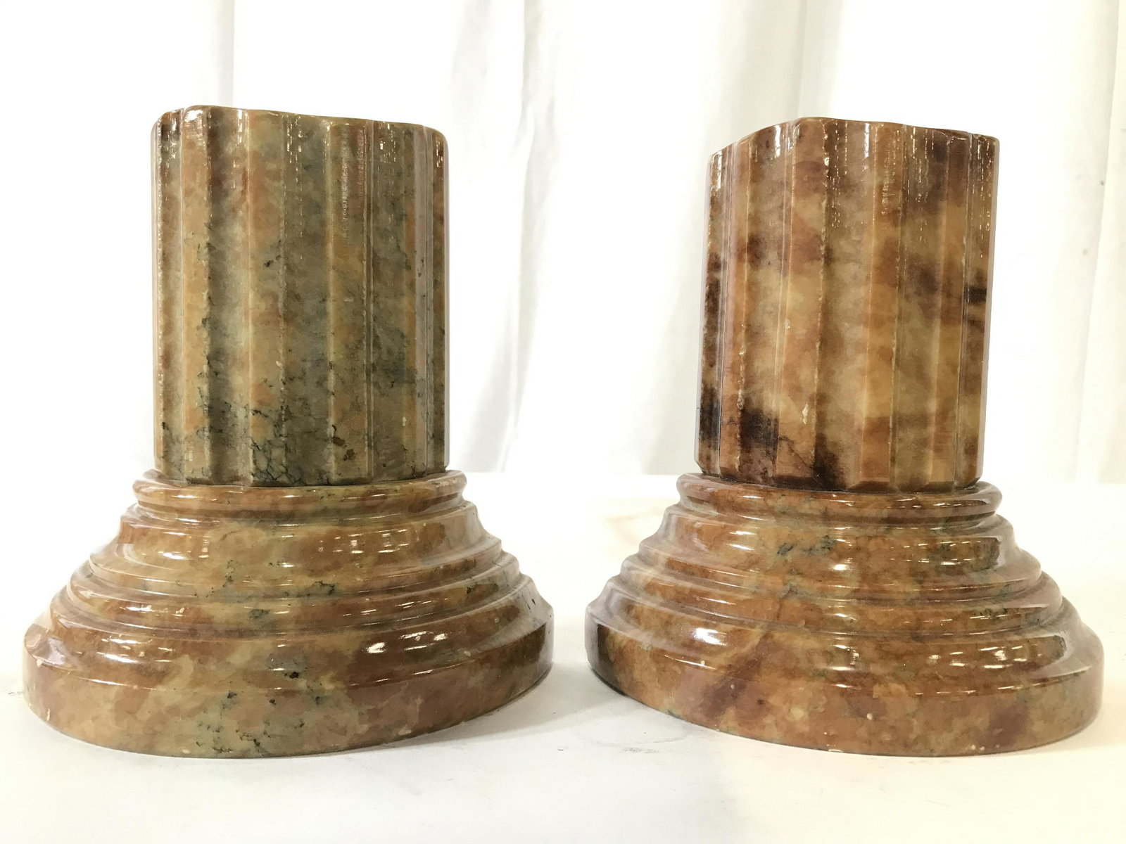 GENUINE ALABASTER Column Base Bookends, Italy: Underside of pieces have tags which read GENUINE ALABASTER MADE IN ITALY. Piece measures approximately 6 inches tall 5.5 inches wide, 3 inches deep. Bookends are alabaster, each piece has shape of col