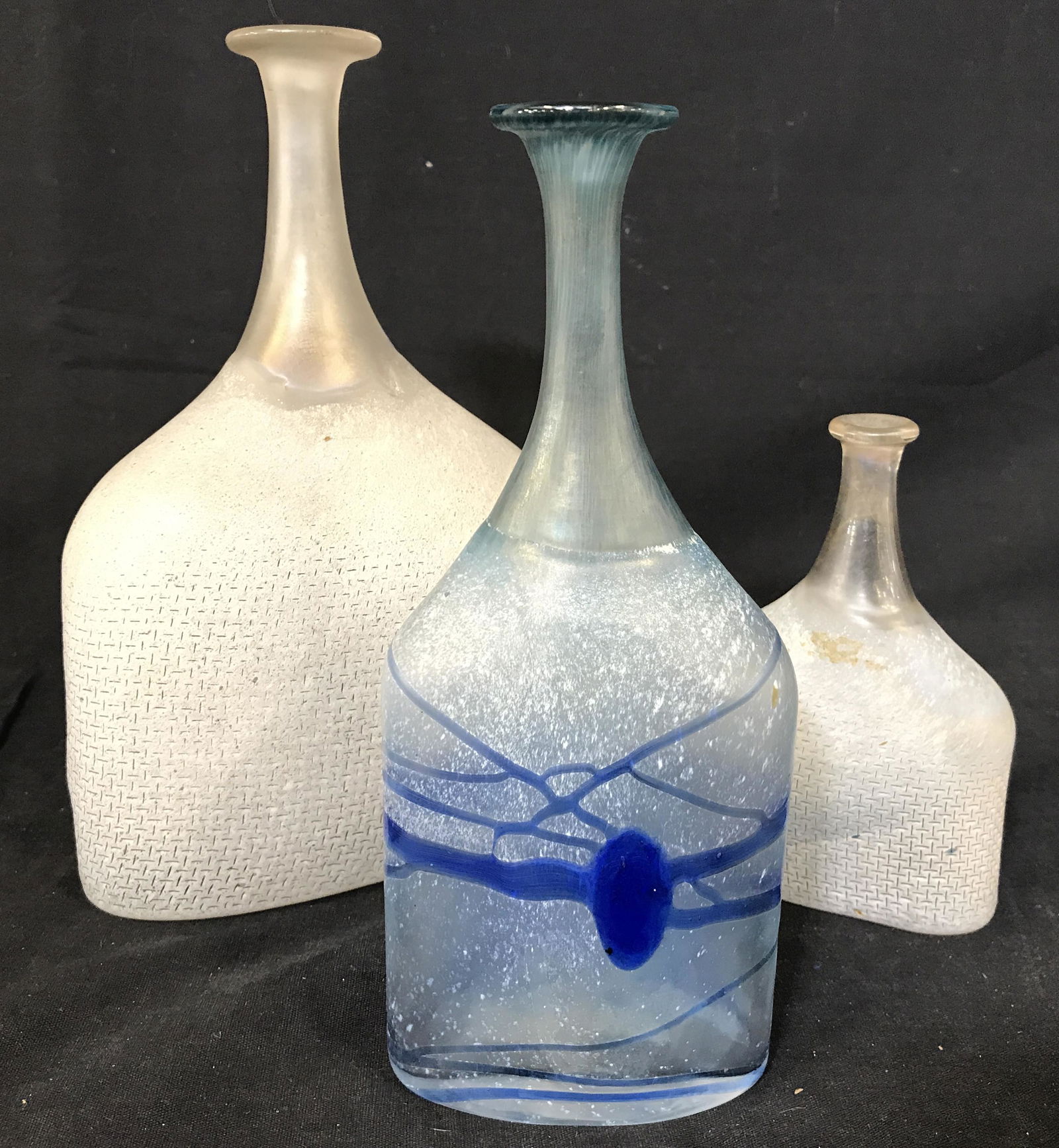 Lot 3 Signed BERTIL VALLIEN Roman Glass Bottles: Undersides are signed BODA BERTIL VALLIEN. Each have unique numbers including 47865, 47862 & 48014. Pieces appear to be hand blown due to Pontil on underside. Lot includes 1 blue toned bottle, 1 large