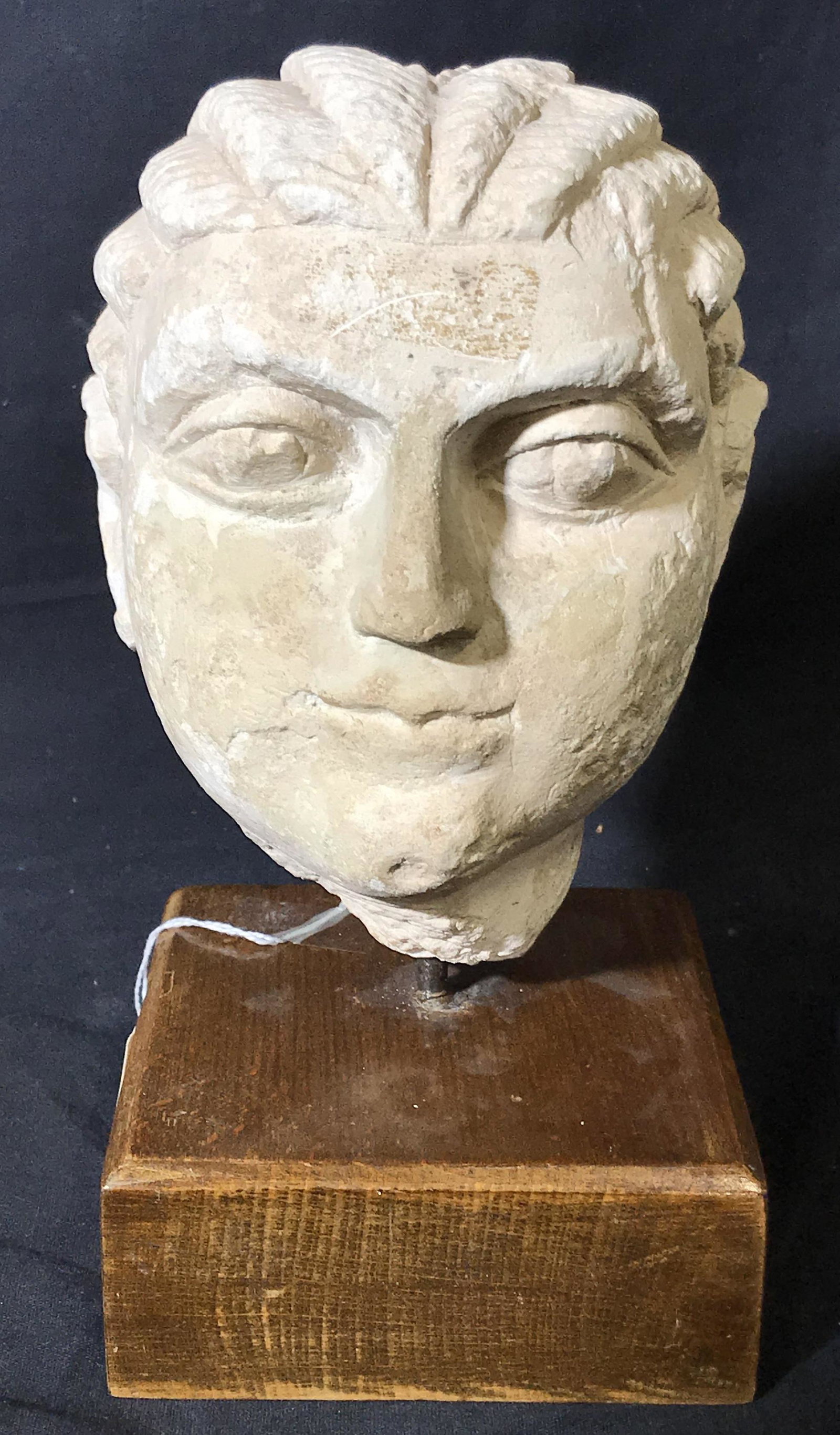 Antique Byzantine Style Head Sculpture: Antique Byzantine style head mounted on wooden platform, tag affixed to platform reads Â‘Ganadaran c.1400, TaxÂ’, possibly marble, possibly plaster, subject a marble head with Byzantine style ey