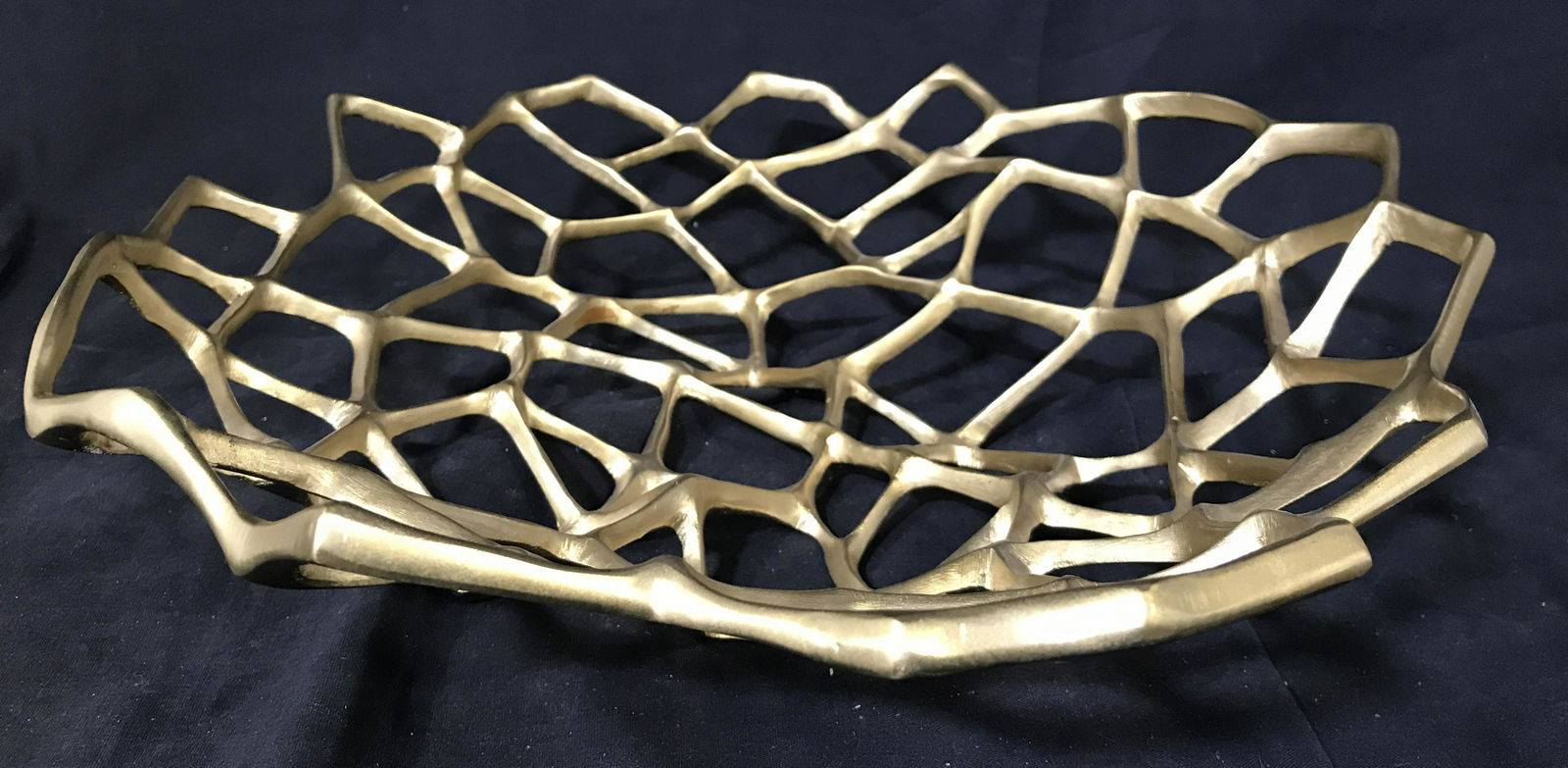 TOM DIXON Gold Toned Brass Centerpiece: Underside is marked TOM DIXON. Centerpiece is brass toned metal. Openwork design, geometric negative spaces, Centerpiece, brass centerpiece, tabletop accessories, brass tabletop, sculptural brass. tab