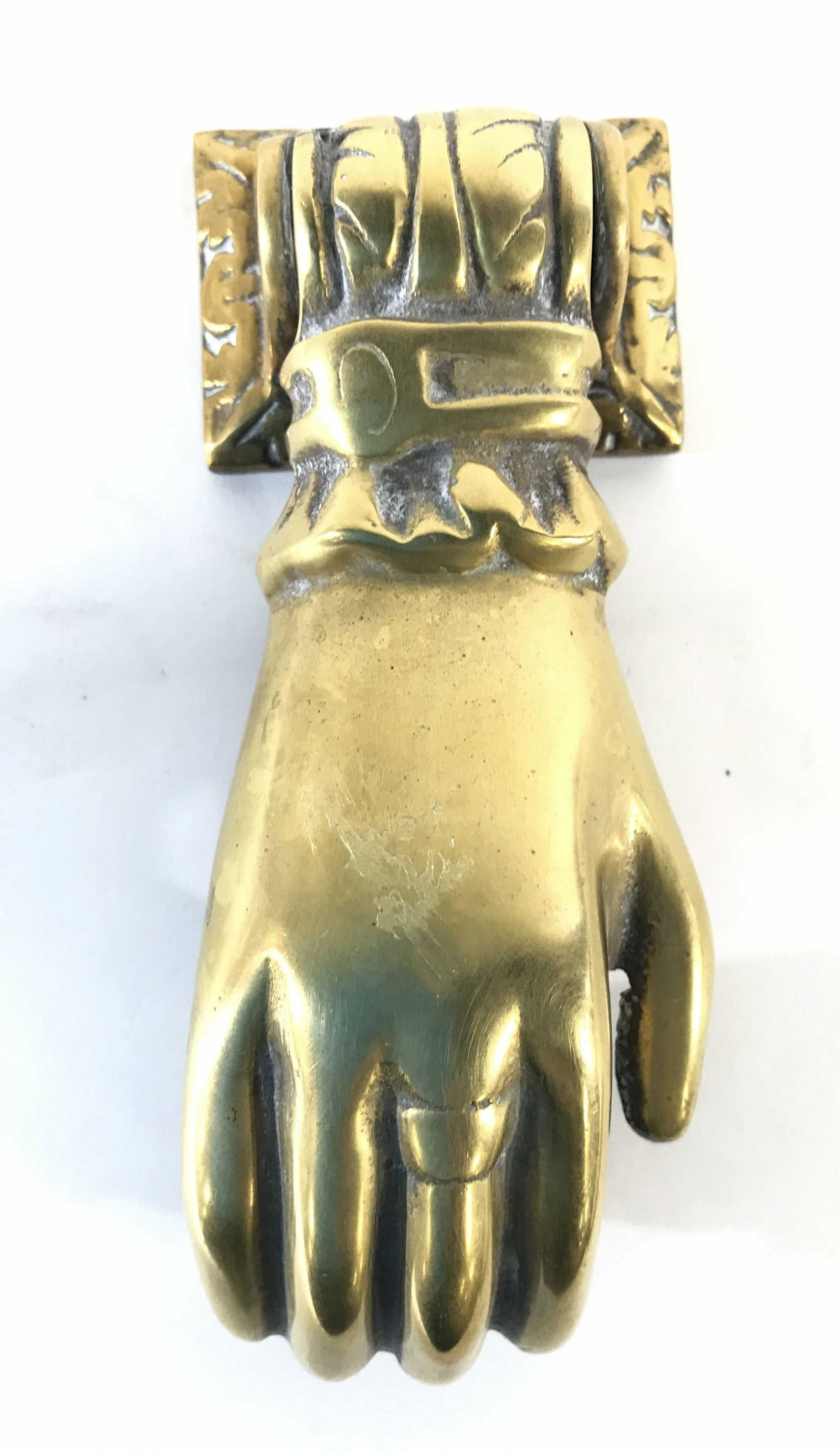 Vintage Brass Hand Shaped Door Knocker: Door knocker is brass toned. Knocker is vintage possibly antique Piece’s shape resembles a hand holding a spherical object. Piece measures approximately 6.5 inches tall 3 inches wide. Door knocker, 