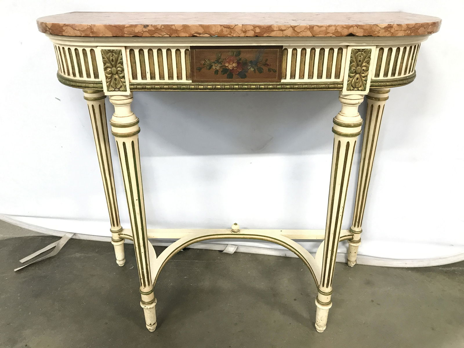Vintage Italian Console Table W Marble Top: Table is vintage possibly antique. Piece has coral toned marble top. Table has 4 carved wooden legs with curved stretcher in between legs. Piece has floral & leaf detail on front which is possibly han