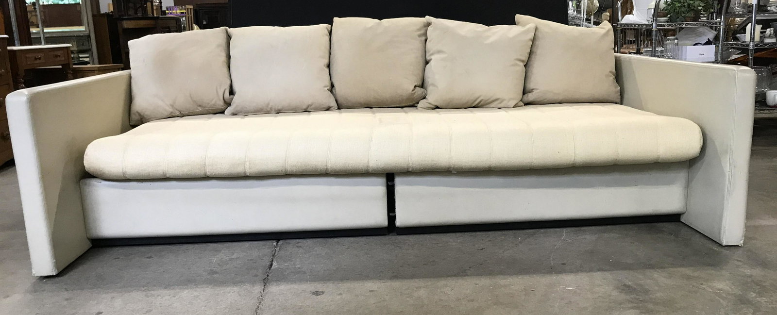 KNOLL INTERNATIONAL Sofa: Underside label reads Knoll International INC, Two piece leather body, connects with wooden dowels, lower black cushion with upper beige cushion and pillows. Evident wear to leather and cushions, 98 i