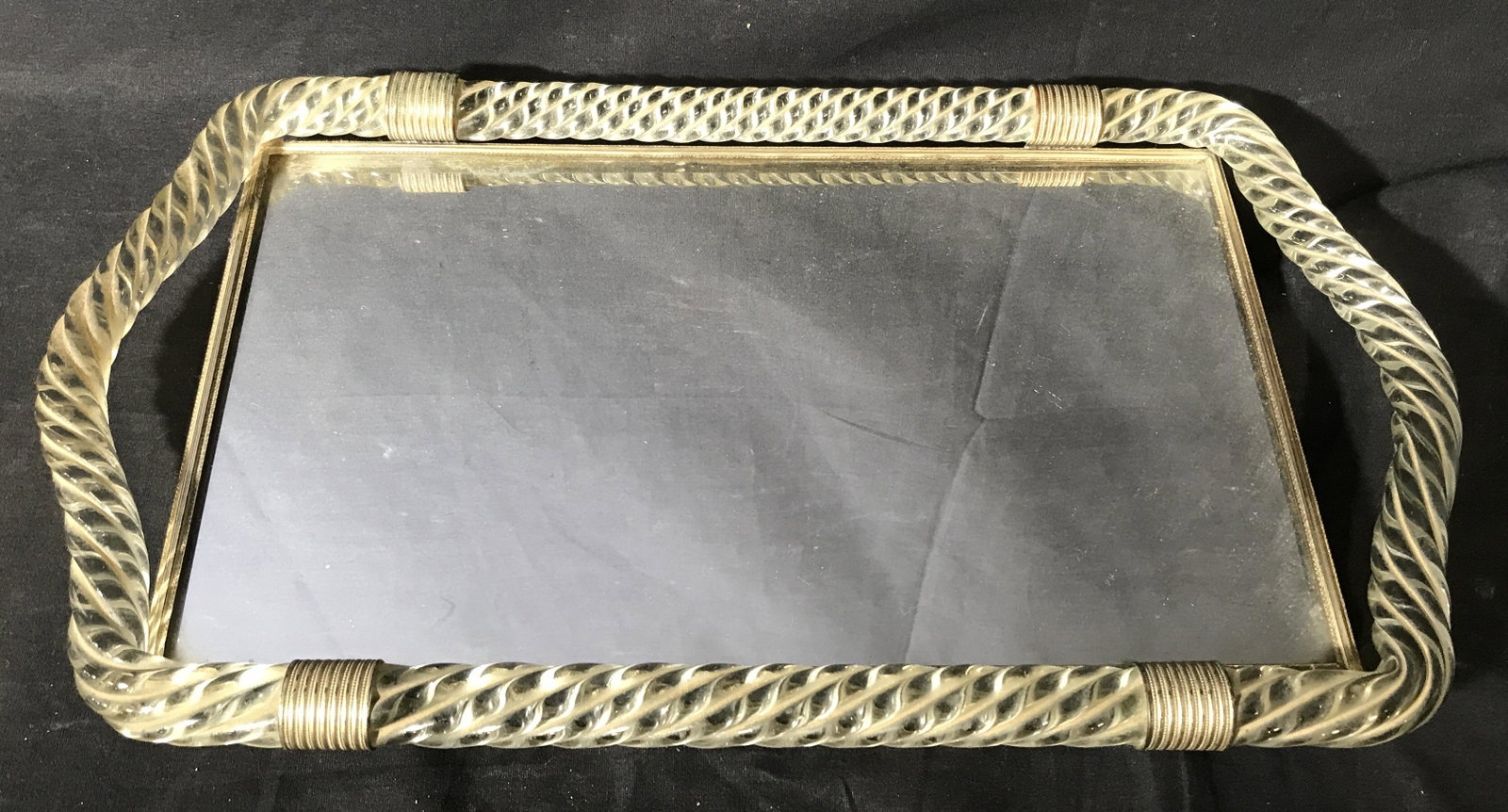 Art Glass Mirrored Vanity Tray: Art Glass Mirrored Vanity Tray, tray consists of a mirrored section with silver toned metal footing and embellishments connecting it to a border and handles made of glass, glass is done in a rope twis