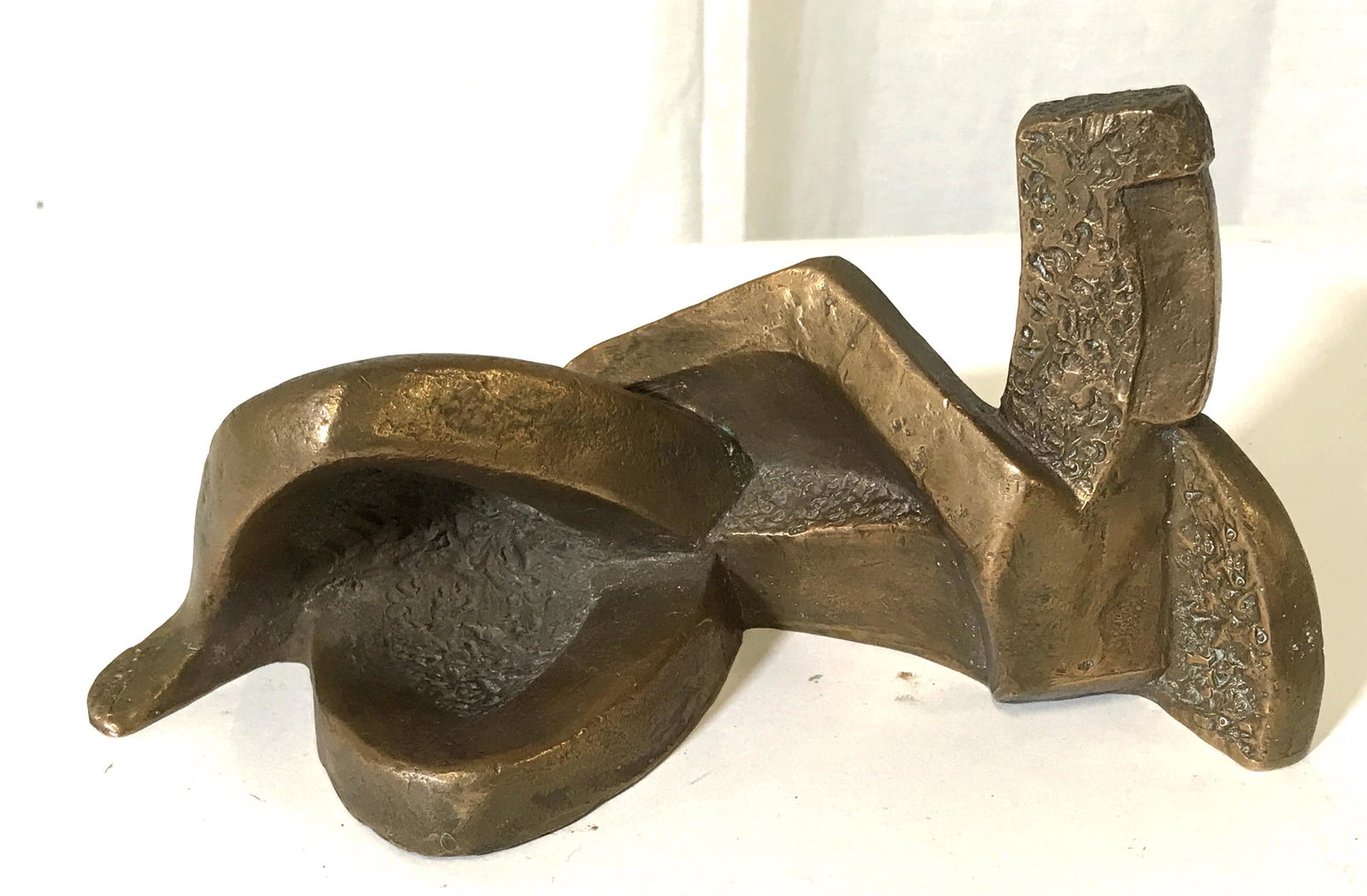 Bronze Abstract Reclining Nude Sculpture: Bronze abstract reclining figure sculpt, no apparent signature, heavy weight object, some polished surfaces some rough, abstract cubism style, measures 8.25 inches long and 4 inches at tallest point, 